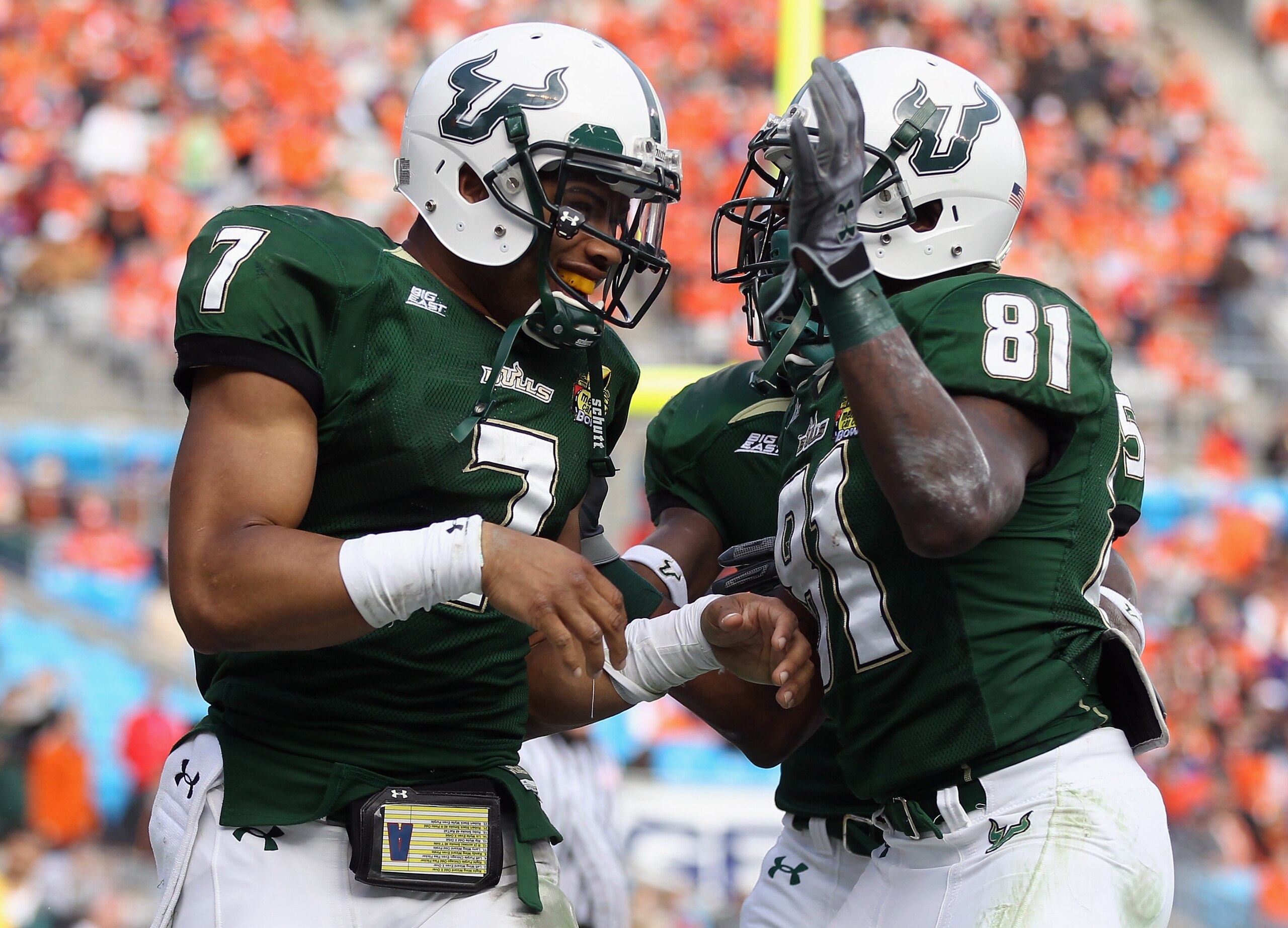 CHARLOTTE, NC - DECEMBER 31: B.J. Daniels #7 of the USF Bulls celebrates after scoring a touchdown with teammate Dontavia Bogan #81 against the Clemson Tigers during their game at Bank of America Stadium on December 31, 2010 in Charlotte, North Carolina. CHARLOTTE, NC - DECEMBER 31: B.J. Daniels #7 of the USF Bulls celebrates after scoring a touchdown with teammate Dontavia Bogan #81 against the Clemson Tigers during their game at Bank of America Stadium on December 31, 2010 in Charlotte, North Carolina.