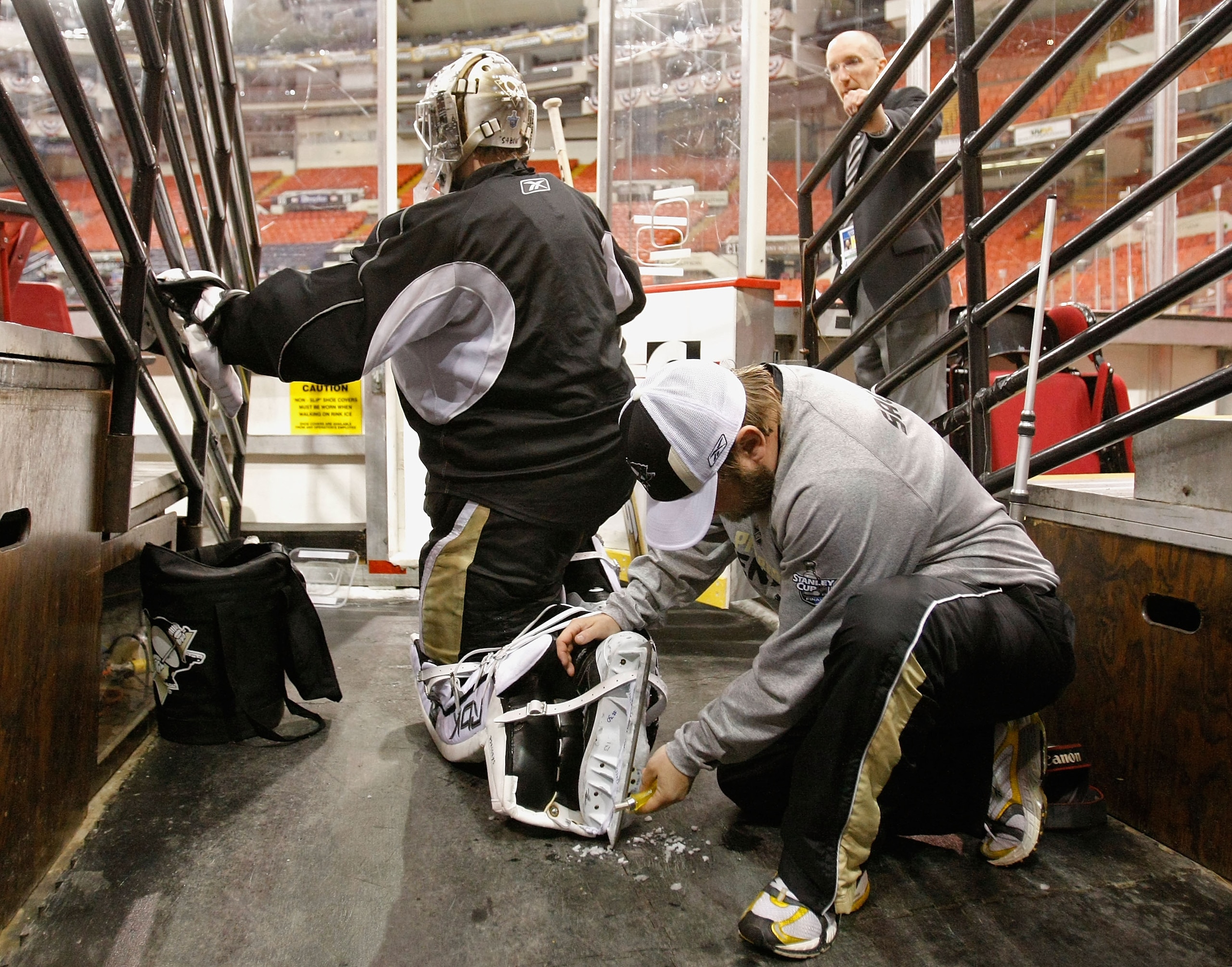 PITTSBURGH - MAY 30: Goaltender Dany Sabourin #30 of the Pittsburgh Penguins has his skates worked on by equipment manager Dana Heinze during a practice for the 2008 NHL Stanley Cup Finals at Mellon Arena on May 30, 2008 in Pittsburgh. Pennsylvania. (Ph PITTSBURGH - MAY 30: Goaltender Dany Sabourin #30 of the Pittsburgh Penguins has his skates worked on by equipment manager Dana Heinze during a practice for the 2008 NHL Stanley Cup Finals at Mellon Arena on May 30, 2008 in Pittsburgh. Pennsylvania. (Ph