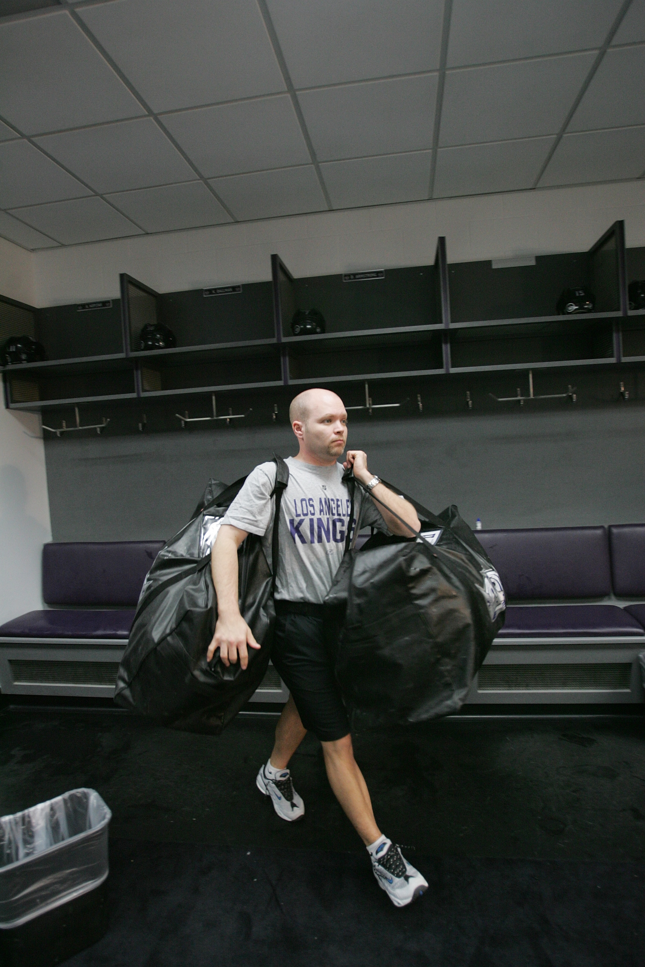 LOS ANGELES - FEBRUARY 1: Equipment manager Darren Granger of the Los Angeles Kings carries bags from the locker room following the game against the Chicago Blackhawks at Staples Center on February 1, 2007 in Los Angeles, California. The Blackhawks won 3 LOS ANGELES - FEBRUARY 1: Equipment manager Darren Granger of the Los Angeles Kings carries bags from the locker room following the game against the Chicago Blackhawks at Staples Center on February 1, 2007 in Los Angeles, California. The Blackhawks won 3