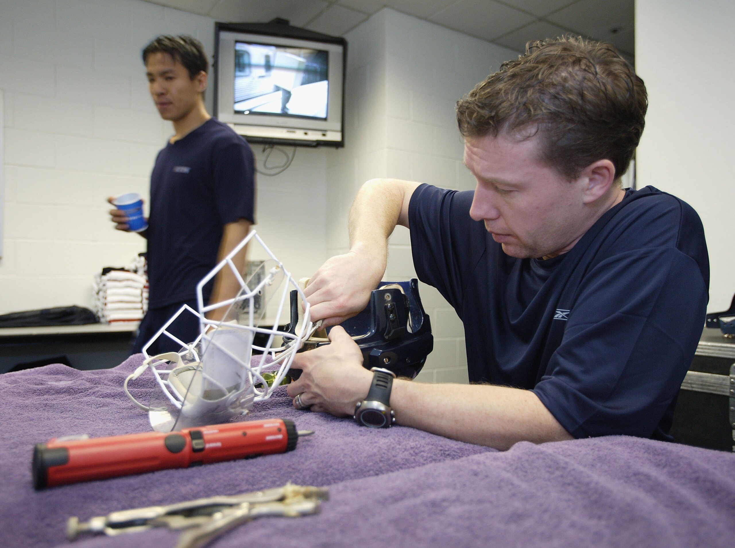 SAN JOSE, CA - NOVEMBER 16: Assistant equipment manager Jamie Hendricks of the Vancouver Canucks works on a goaltender's mask before the NHL game against the San Jose Sharks on November 16, 2005 at HP Pavilion At San Jose in San Jose, California. (Photo SAN JOSE, CA - NOVEMBER 16: Assistant equipment manager Jamie Hendricks of the Vancouver Canucks works on a goaltender's mask before the NHL game against the San Jose Sharks on November 16, 2005 at HP Pavilion At San Jose in San Jose, California. (Photo