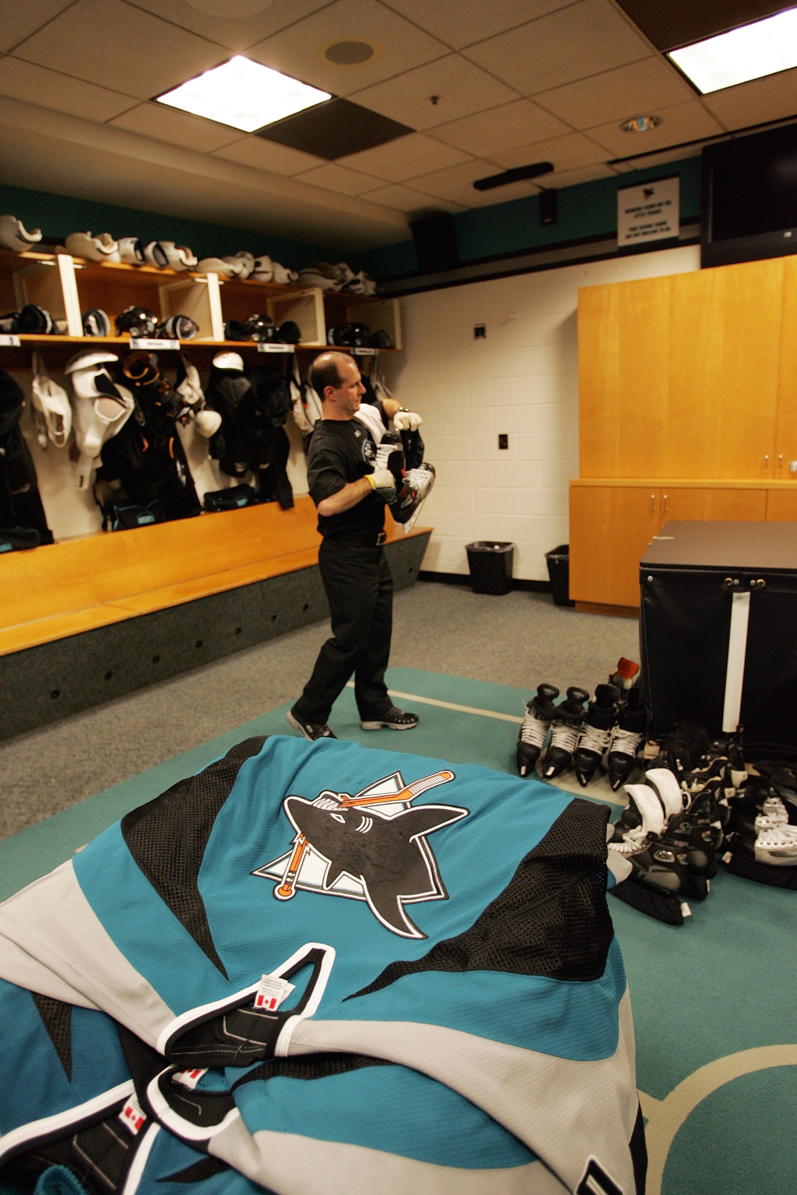 SAN JOSE, CA - JANUARY 30: San Jose Sharks equipment manager Mike Aldrich works in the locker room following the game against the Dallas Stars on January 30, 2007 at HP Pavilion in San Jose, California. The Stars won 3-2 in a shootout. (Photo by Bruce Be SAN JOSE, CA - JANUARY 30: San Jose Sharks equipment manager Mike Aldrich works in the locker room following the game against the Dallas Stars on January 30, 2007 at HP Pavilion in San Jose, California. The Stars won 3-2 in a shootout. (Photo by Bruce Be
