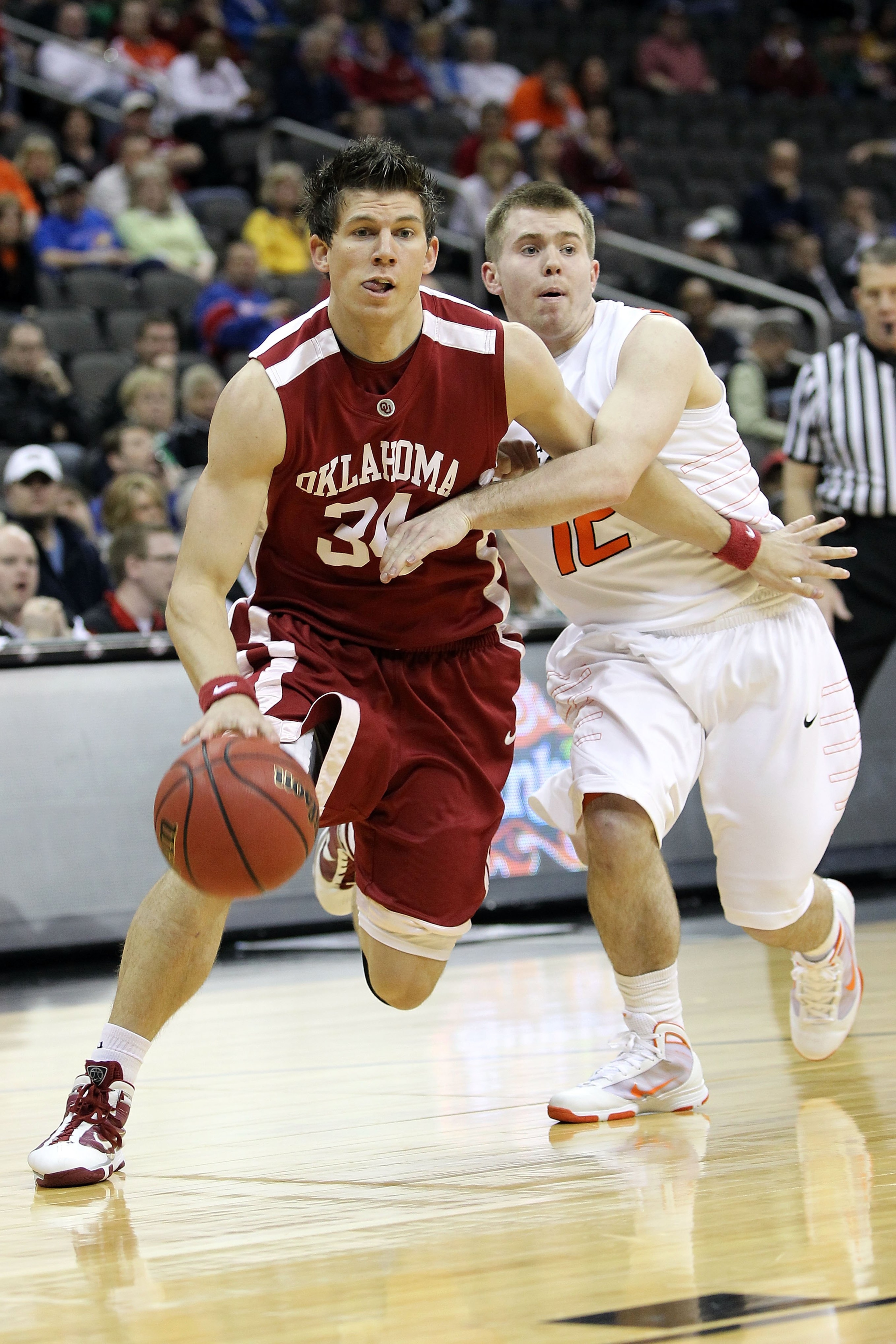 KANSAS CITY, MO - MARCH 10:  Cade Davis #34 of the Oklahoma Sooners drives on Keiton Page #12 of the Oklahoma State Cowboys during the first round game of the 2010 Phillips 66 Big 12 Men's Basketball Tournament at the Sprint Center on March 10, 2010 in Ka