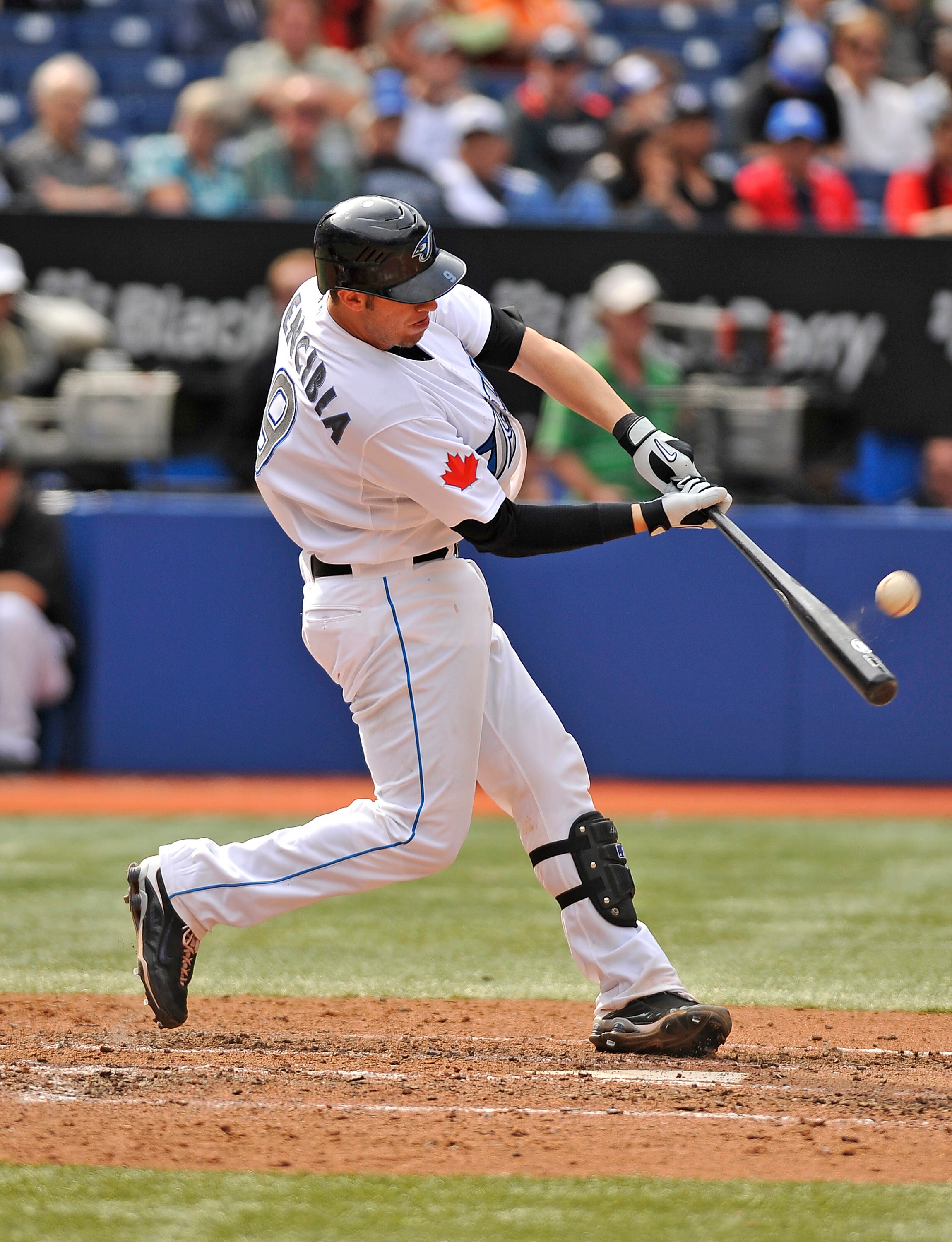 TORONTO - SEPTEMBER 23:   J.P. Arencibia #9 of the Toronto Blue Jays makes contact with the ball during game action against the Seattle Mariners September 23, 2010 at Rogers Centre in Toronto, Ontario, Canada. (Photo by Brad White/Getty Images)