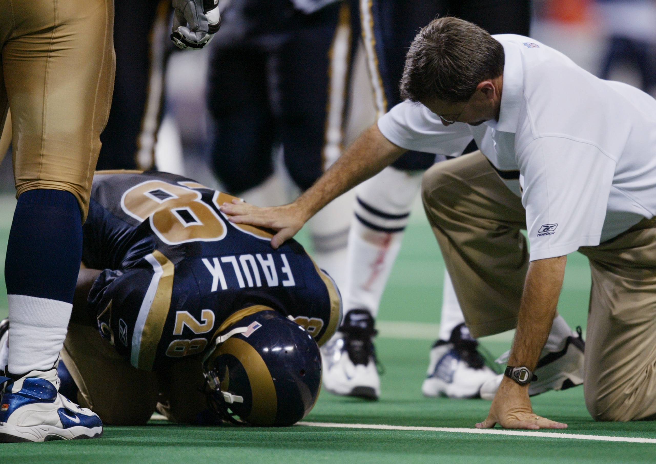 ST. LOUIS - NOVEMBER 10: Running Back Marshall Faulk #28 of the St. Louis Rams is injured on the field during the NFL game against the San Diego Chargers at the Edward Jones Dome on November 10, 2002 in St. Louis, Missouri. The Rams defeated the Charger ST. LOUIS - NOVEMBER 10: Running Back Marshall Faulk #28 of the St. Louis Rams is injured on the field during the NFL game against the San Diego Chargers at the Edward Jones Dome on November 10, 2002 in St. Louis, Missouri. The Rams defeated the Charger