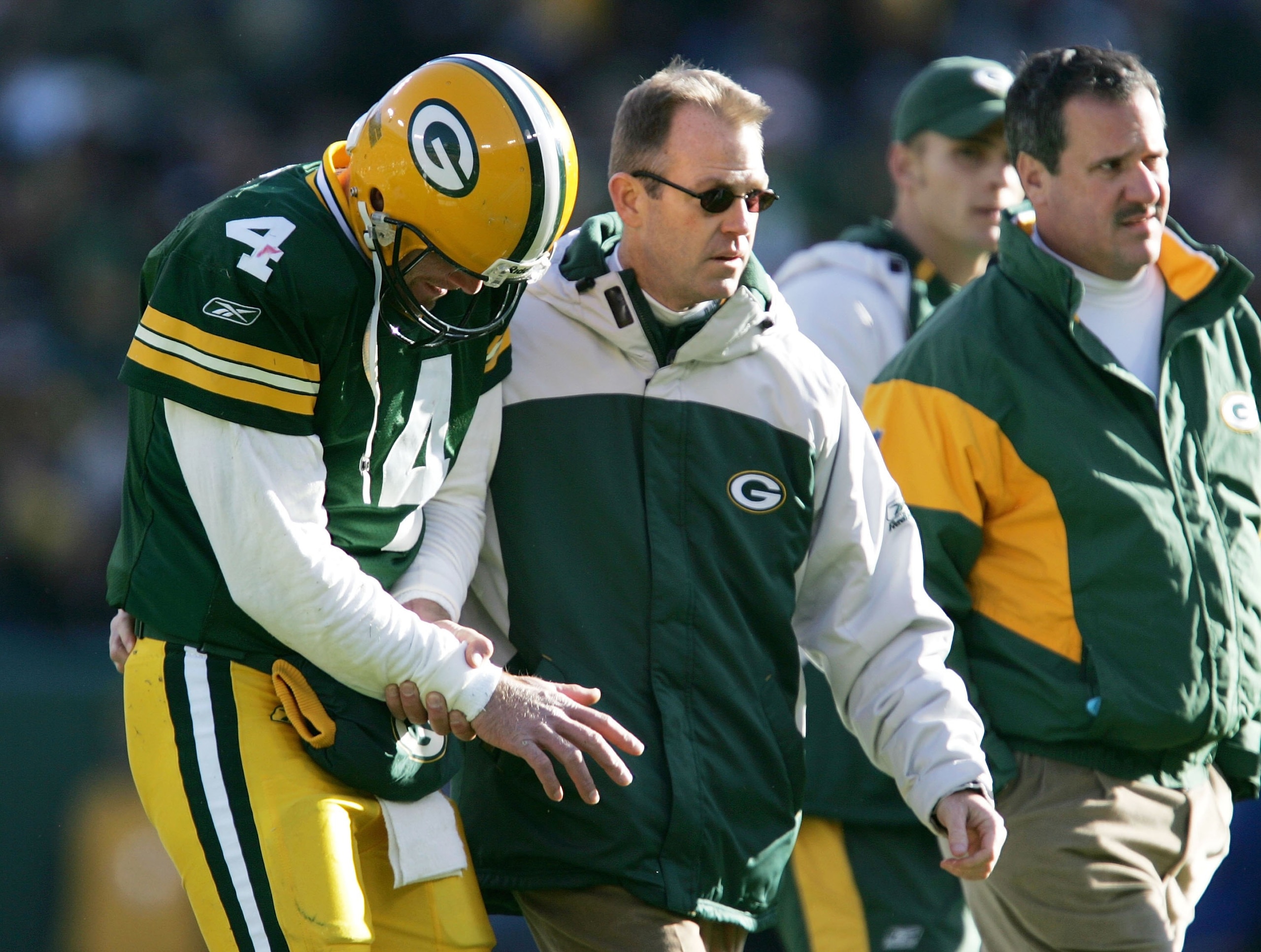 GREEN BAY, WI - NOVEMBER 19: Brett Favre #4 of the Green Bay Packers is lead off the field by team doctors after injuring his arm on a sack by the New England Patriots on November 19, 2006 at Lambeau Field in Green Bay, Wisconsin. (Photo by Jonathan Dan GREEN BAY, WI - NOVEMBER 19: Brett Favre #4 of the Green Bay Packers is lead off the field by team doctors after injuring his arm on a sack by the New England Patriots on November 19, 2006 at Lambeau Field in Green Bay, Wisconsin. (Photo by Jonathan Dan