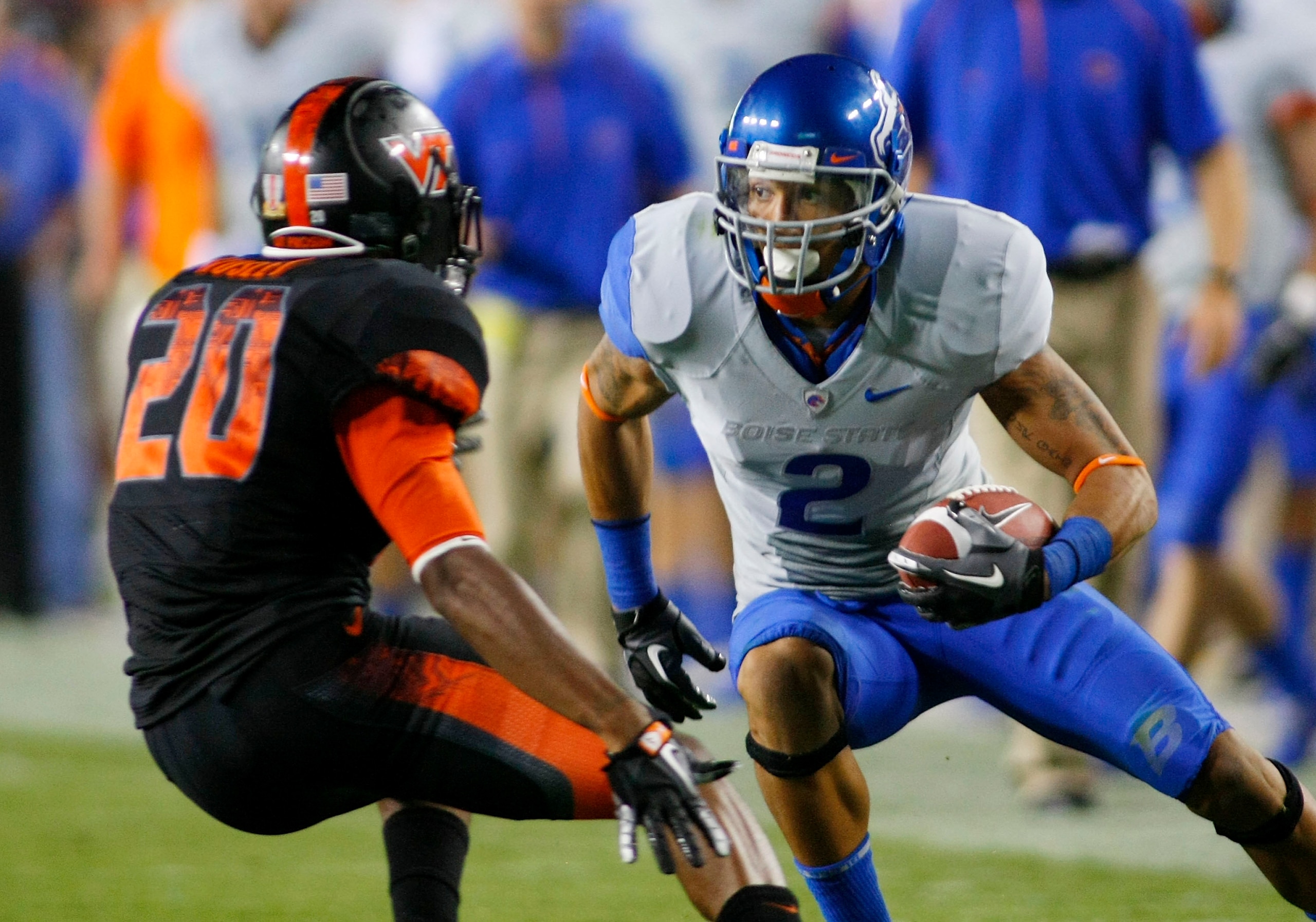 LANDOVER, MD - SEPTEMBER 06:  Wide receiver #2 Austin Pettis of the Boise State Broncos tries to avoid cornerback #21 Rashad Carmichael of the Virginia Tech Hokies at FedExField on September 6, 2010 in Landover, Maryland.  (Photo by Geoff Burke/Getty Imag