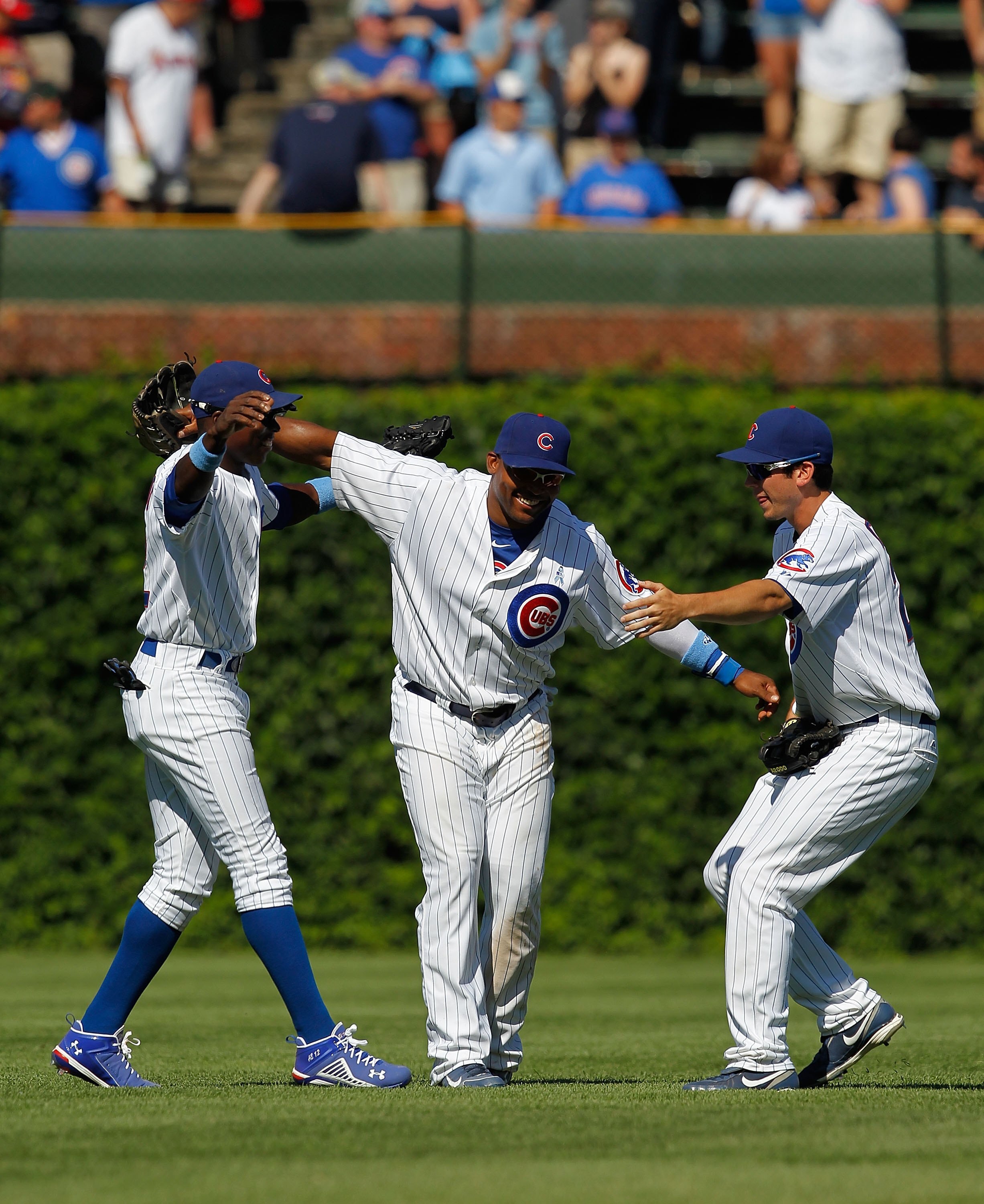 CHICAGO - JUNE 20: (L-R) Alfonso Soriano #12, Marlon Byrd #24 and Tyler Colvin #21 of the Chicago Cubs celebrate a win over the Los Angeles Angels of Anaheim at Wrigley Field on June 20, 2010 in Chicago, Illinois. The Cubs defeated the Angels 12-1. (Photo