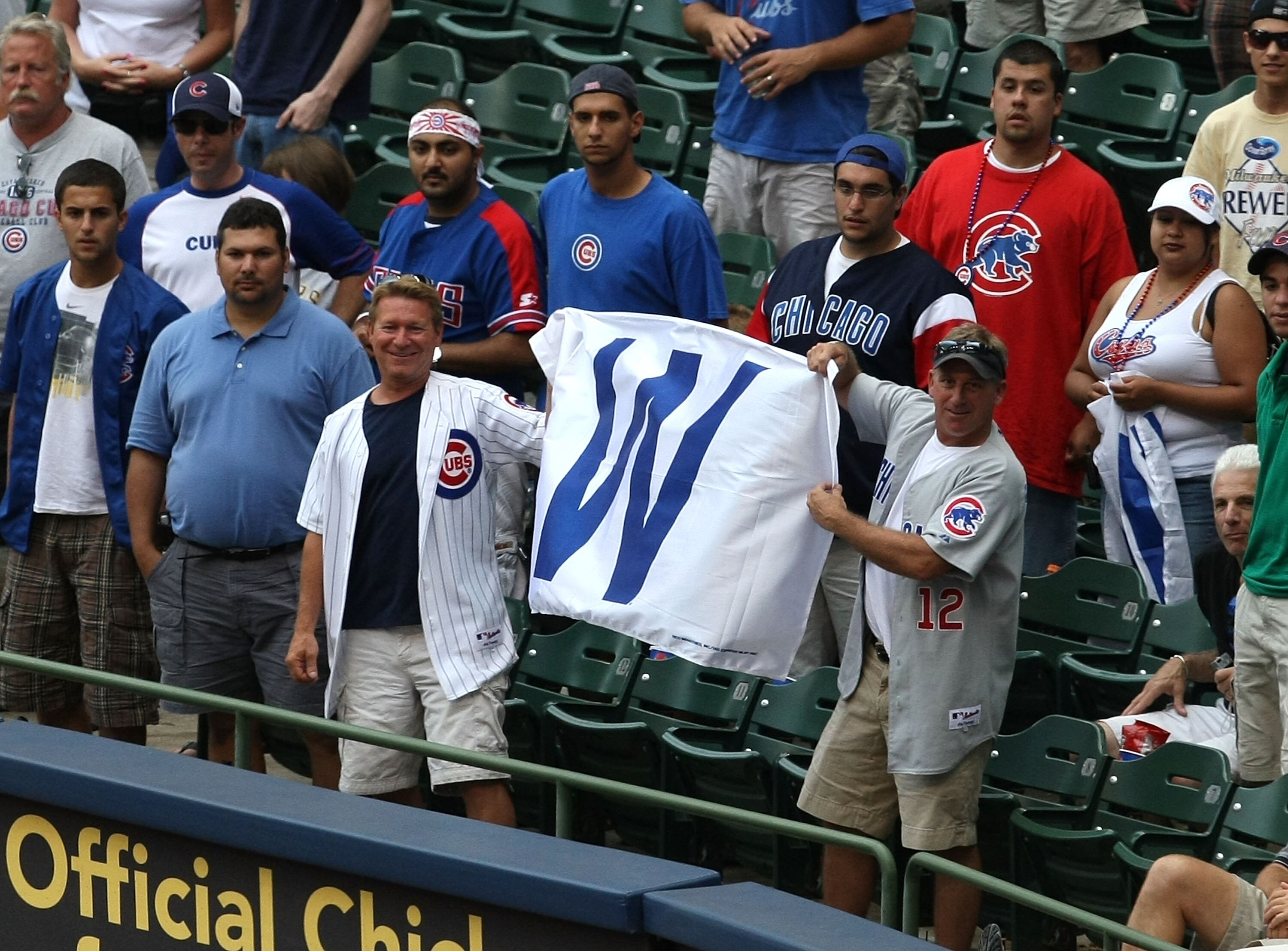 MILWAUKEE - JULY 31:  Fans of the Chicago Cubs hold up a win flag along the first baseline after the Cubs complete a four game sweep of the Milwaukee Brewers at Miller Park on July 31, 2008 in Milwaukee, Wisconsin. The Cubs defeated the Brewers 11-4.  (Ph