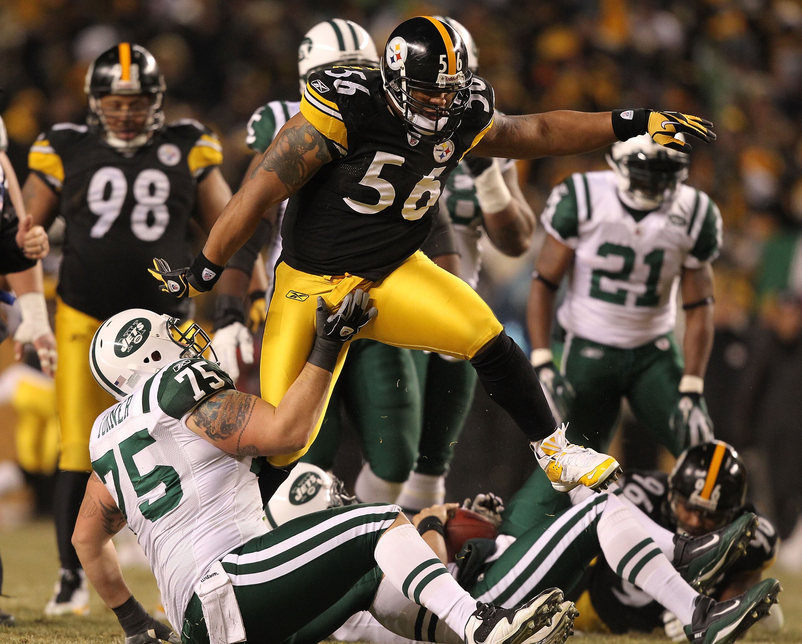 PITTSBURGH, PA - JANUARY 23:  LaMarr Woodley #56 of the Pittsburgh Steelers jumps over Robert Turner #75 of the New York Jets after a sack during the 2011 AFC Championship game at Heinz Field on January 23, 2011 in Pittsburgh, Pennsylvania.  (Photo by Al