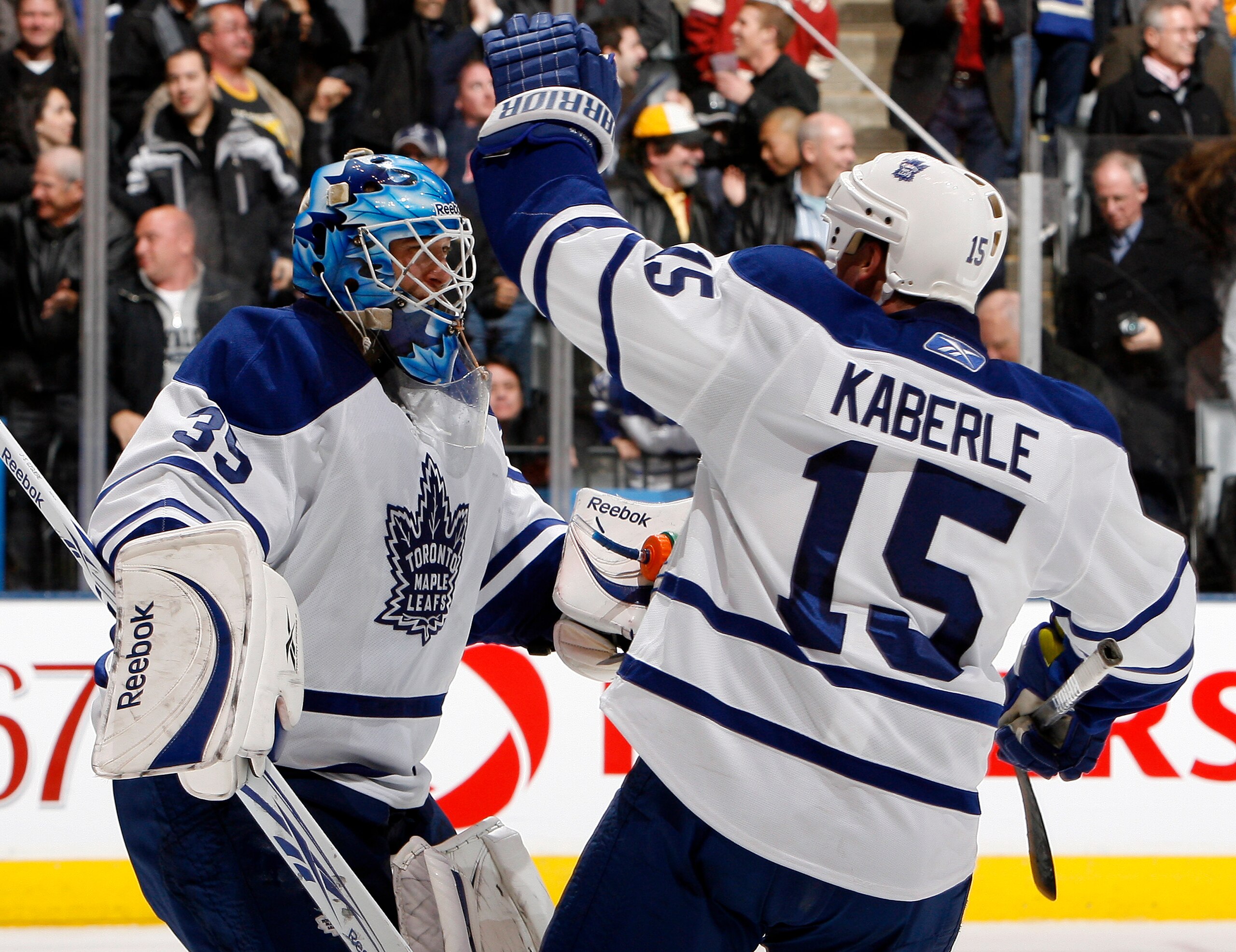 TORONTO, CANADA - DECEMBER 4: Jean-Sebastien Giguere #35 and Tomas Kaberle #15 of the Toronto Maple Leafs celebrate shoot-out win against the Boston Bruins during game action at the Air Canada Centre December 4, 2010 in Toronto, Ontario, Canada. (Photo by