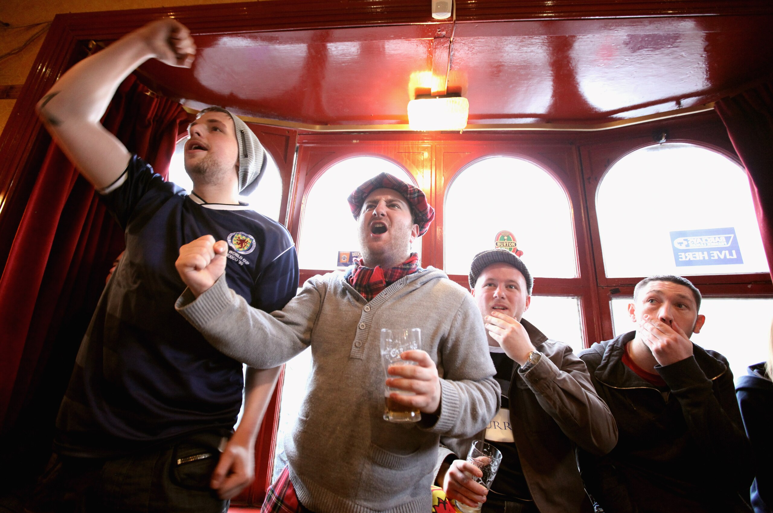 DUNBLANE, SCOTLAND - JANUARY 30:  Fans of tennis player Andy Murray, react as they watch his AAustralian Open final match against Novak Djokivic, in the bar of The Dunblane Hotel in his hometown on January 30, 2011 in Dunblane, Scotland. Andy Murray lost