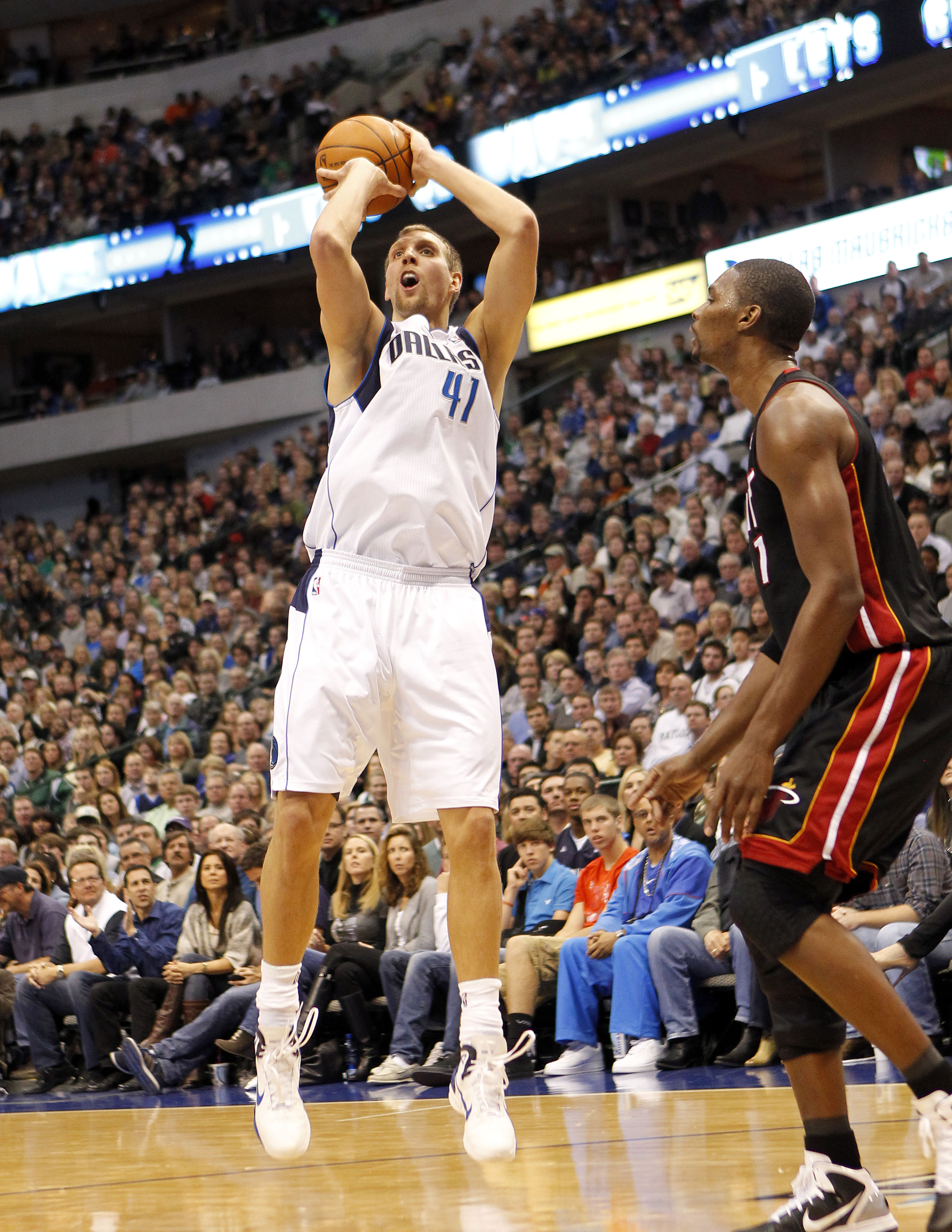 DALLAS - NOVEMBER 27: Dirk Nowitzki #41 of the Dallas Mavericks shoots over Chris Bosh #1 of the Miami Heat on November 27, 2010 at the American Airlines Center in Dallas, Texas. NOTE TO USER: User expressly acknowledges and agrees that, by downloading an