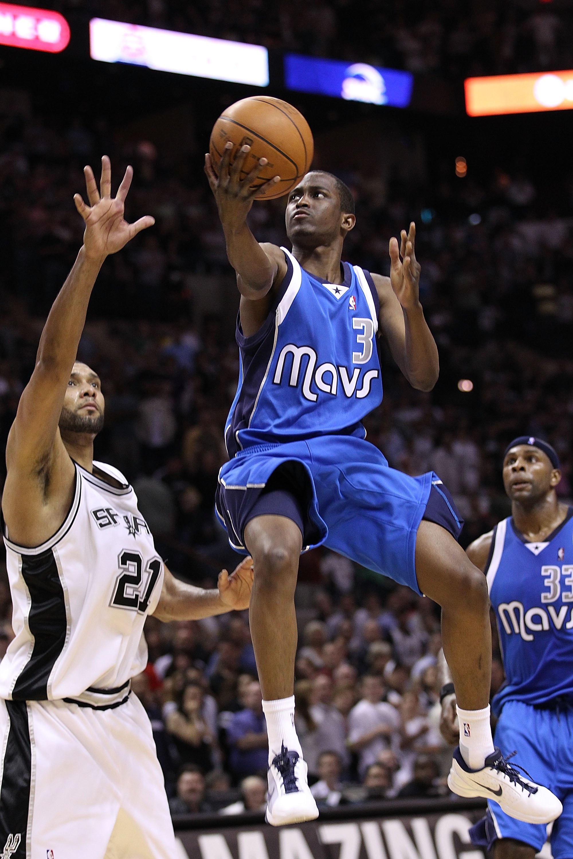 SAN ANTONIO - APRIL 23:  Guard Rodrigue Beaubois #3 of the Dallas Mavericks takes a shot against Tim Duncan #21 of the San Antonio Spurs in Game Three of the Western Conference Quarterfinals during the 2010 NBA Playoffs at AT&T Center on April 23, 2010 in
