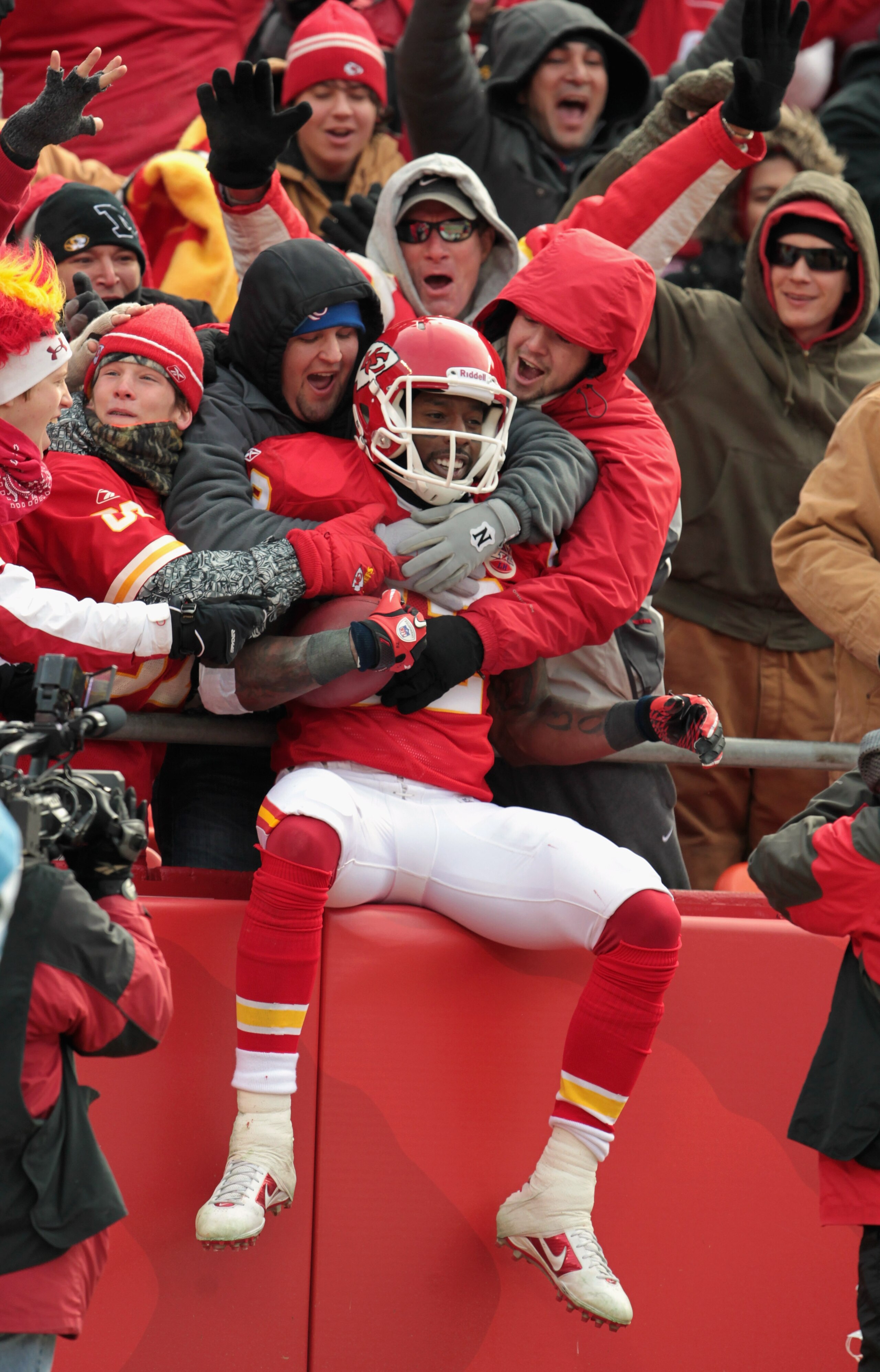 KANSAS CITY, MO - DECEMBER 26:  Receiver Dwayne Bowe #82 of the Kansas City Chiefs is congratulated by fans as he jumps into the stands after making a 75 yard touchdown catch during the game against the Tennessee Titans on December 26, 2010 at Arrowhead S