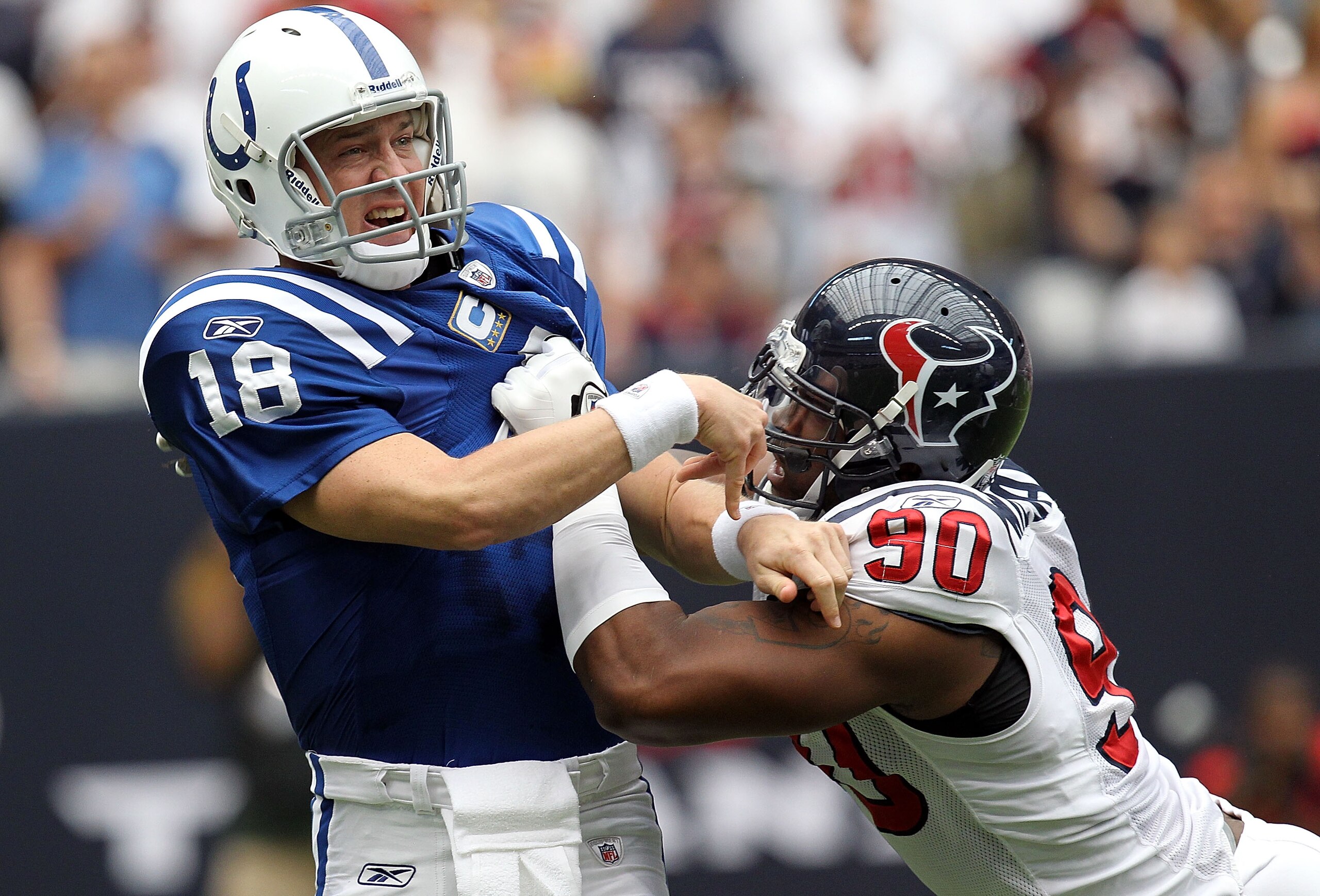 HOUSTON - SEPTEMBER 12:  Quarterback Peyton Manning #18 of the Indianapolis Colts is tackled by Mario Williams #90 of the Houston Texans during the NFL season opener at Reliant Stadium on September 12, 2010 in Houston, Texas.  (Photo by Ronald Martinez/Ge