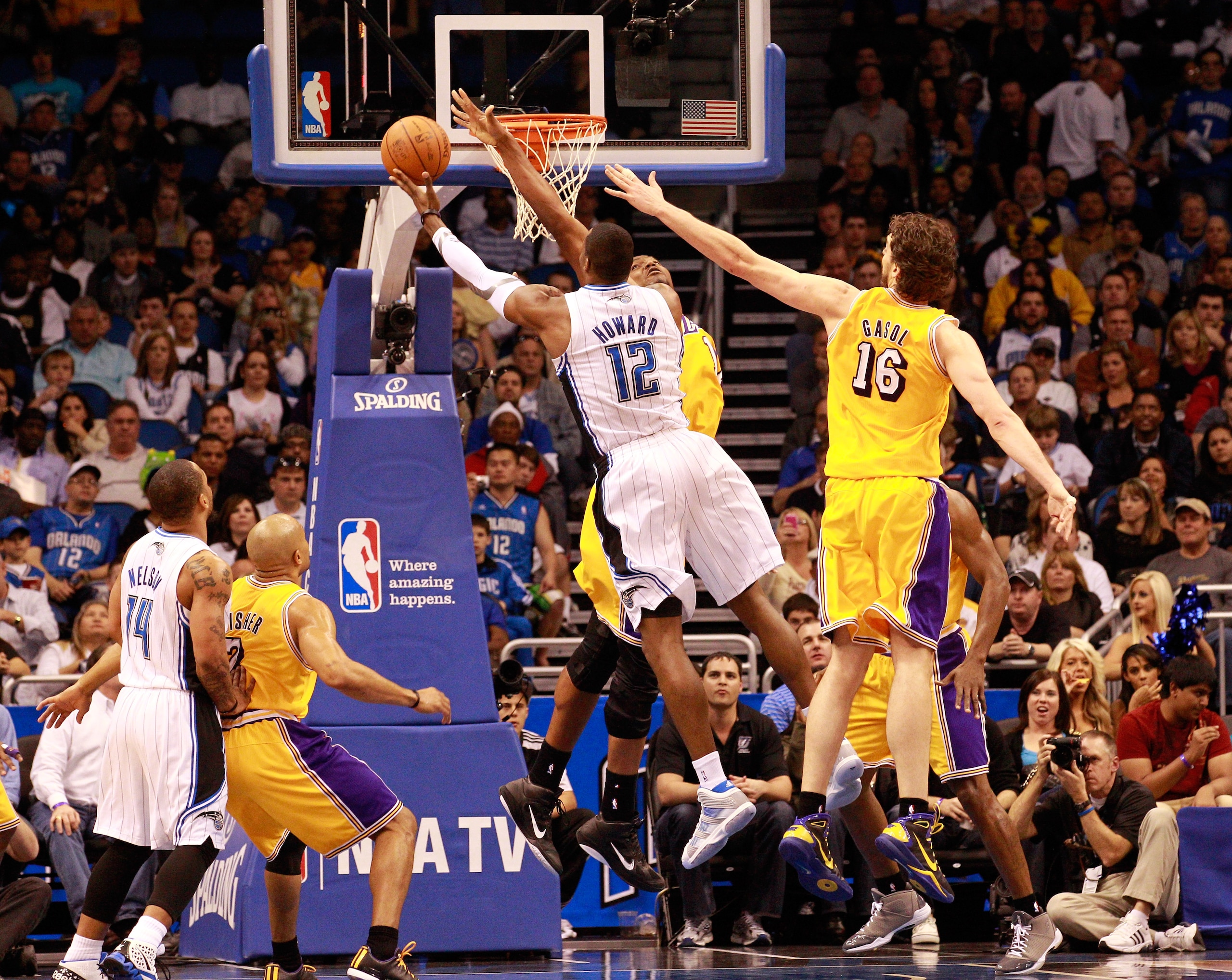 ORLANDO, FL - FEBRUARY 13:  Dwight Howard #12 of the Orlando Magic attempts a shot over Pau Gasol #16 and Andrew Bynum #17 of the Los Angeles Lakers during the game at Amway Arena on February 13, 2011 in Orlando, Florida.  NOTE TO USER: User expressly ack