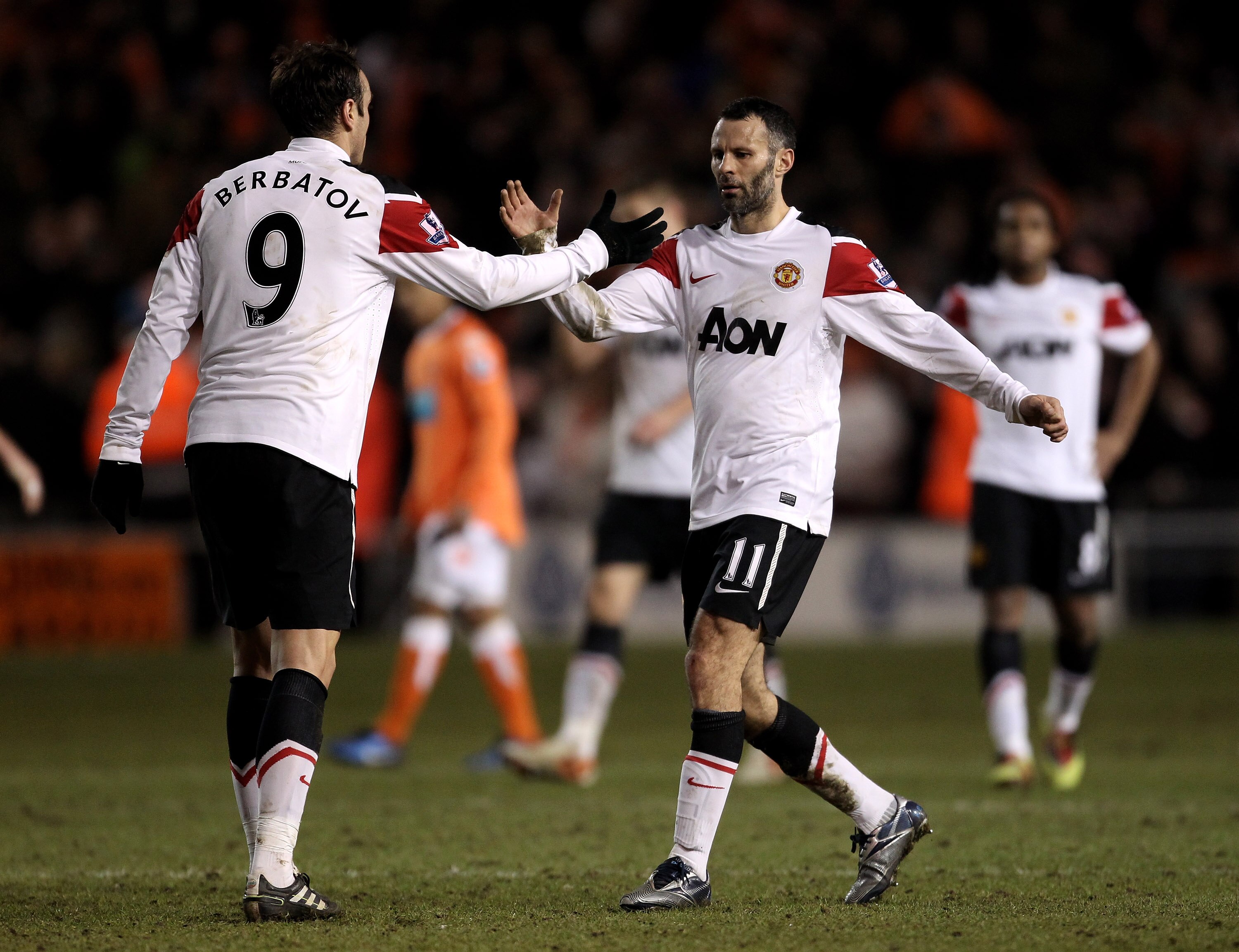 BLACKPOOL, ENGLAND - JANUARY 25:  Ryan Giggs of Manchester United celebrates with team mate Dimitar Berbatov (L) at the end of the Barclays Premier League match between Blackpool and Manchester United at Bloomfield Road on January 25, 2011 in Blackpool, E