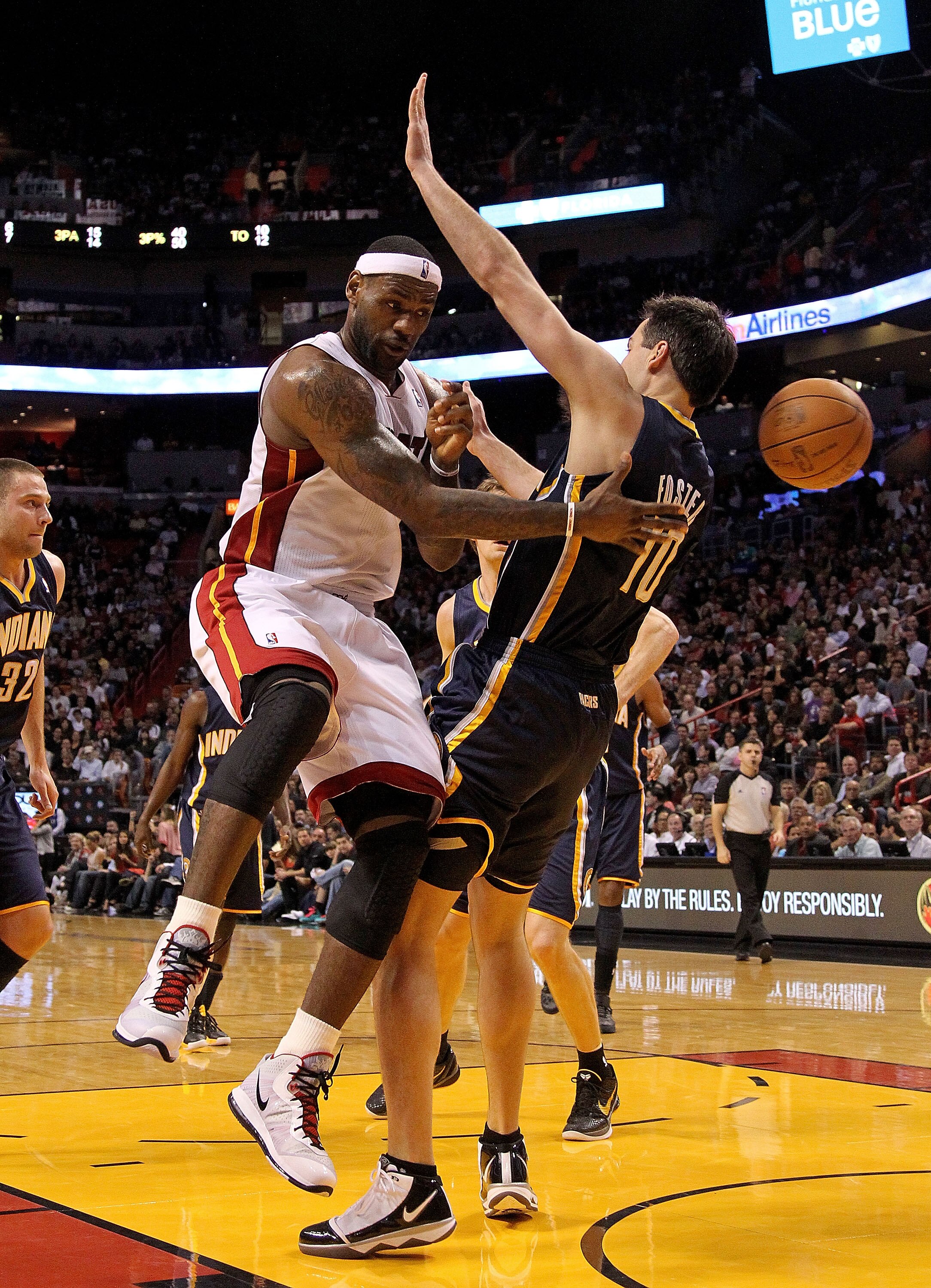 MIAMI, FL - FEBRUARY 08:  LeBron James #6 of the Miami Heat passes around Jeff Foster #10 of the Indiana Pacers during a game at American Airlines Arena on February 8, 2011 in Miami, Florida. NOTE TO USER: User expressly acknowledges and agrees that, by d