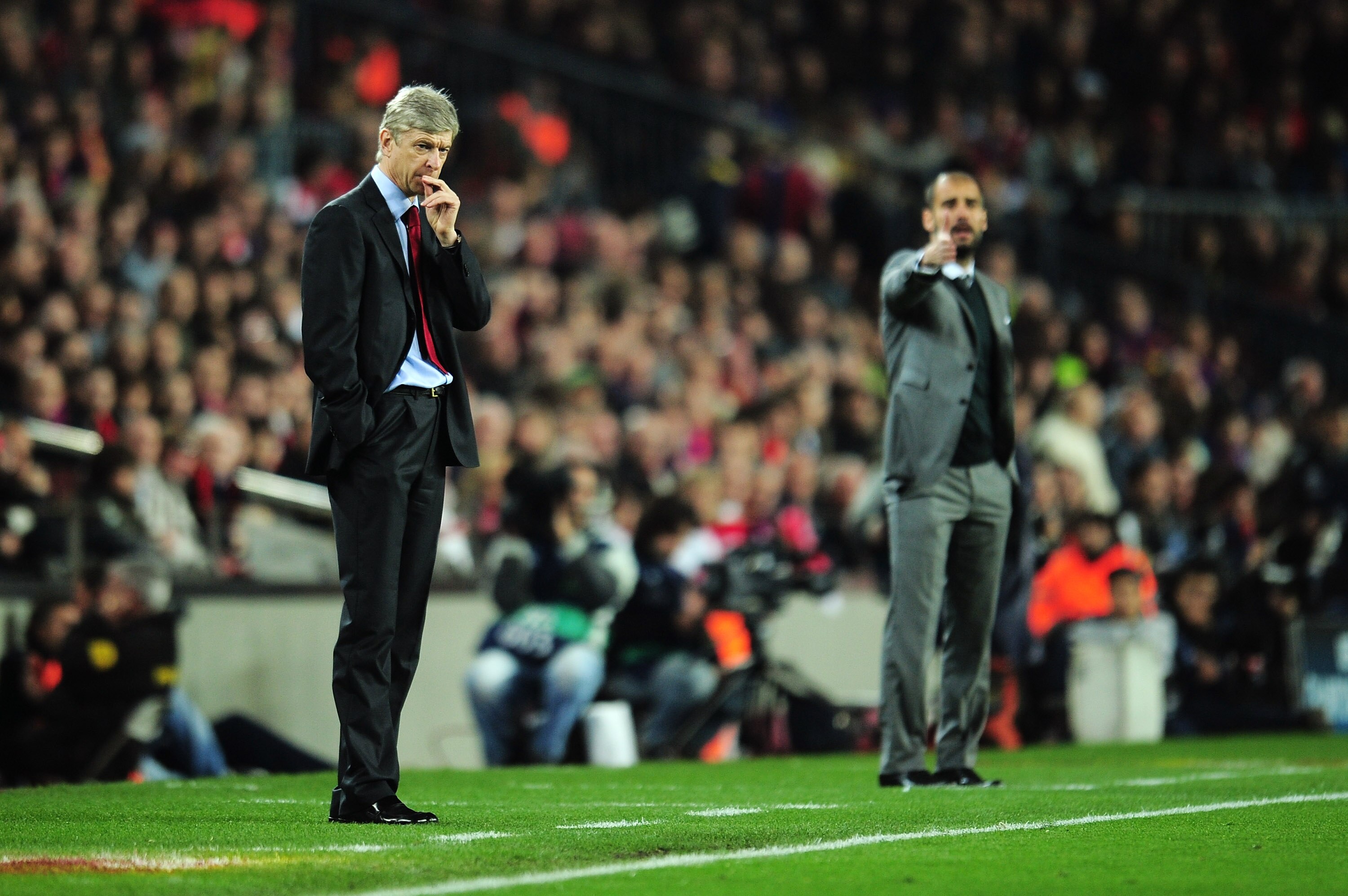 BARCELONA, SPAIN - APRIL 06:  Manager of Arsenal Arsene Wenger and manager of Barcelona Josep Guardiola react on the touchline during the UEFA Champions League quarter final second leg match between Barcelona and Arsenal at Camp Nou on April 6, 2010 in Ba