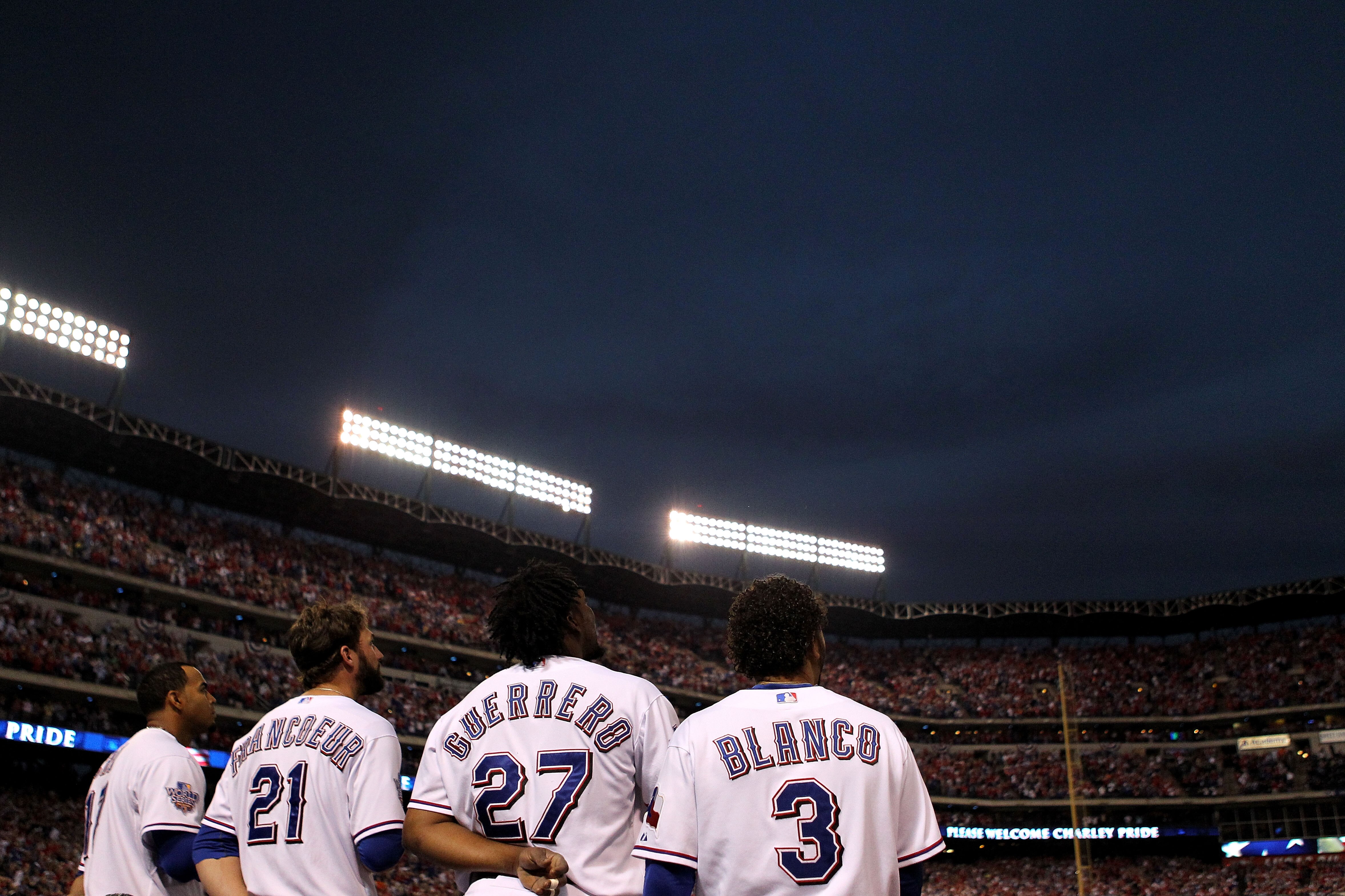 ARLINGTON, TX - NOVEMBER 01:  (L-R) Nelson Cruz #17, Jeff Francoeur #21, Vladimir Guerrero #27 and Andres Blanco #3 of the Texas Rangers stand for the performance of the National Anthem against the San Francisco Giants in Game Five of the 2010 MLB World S