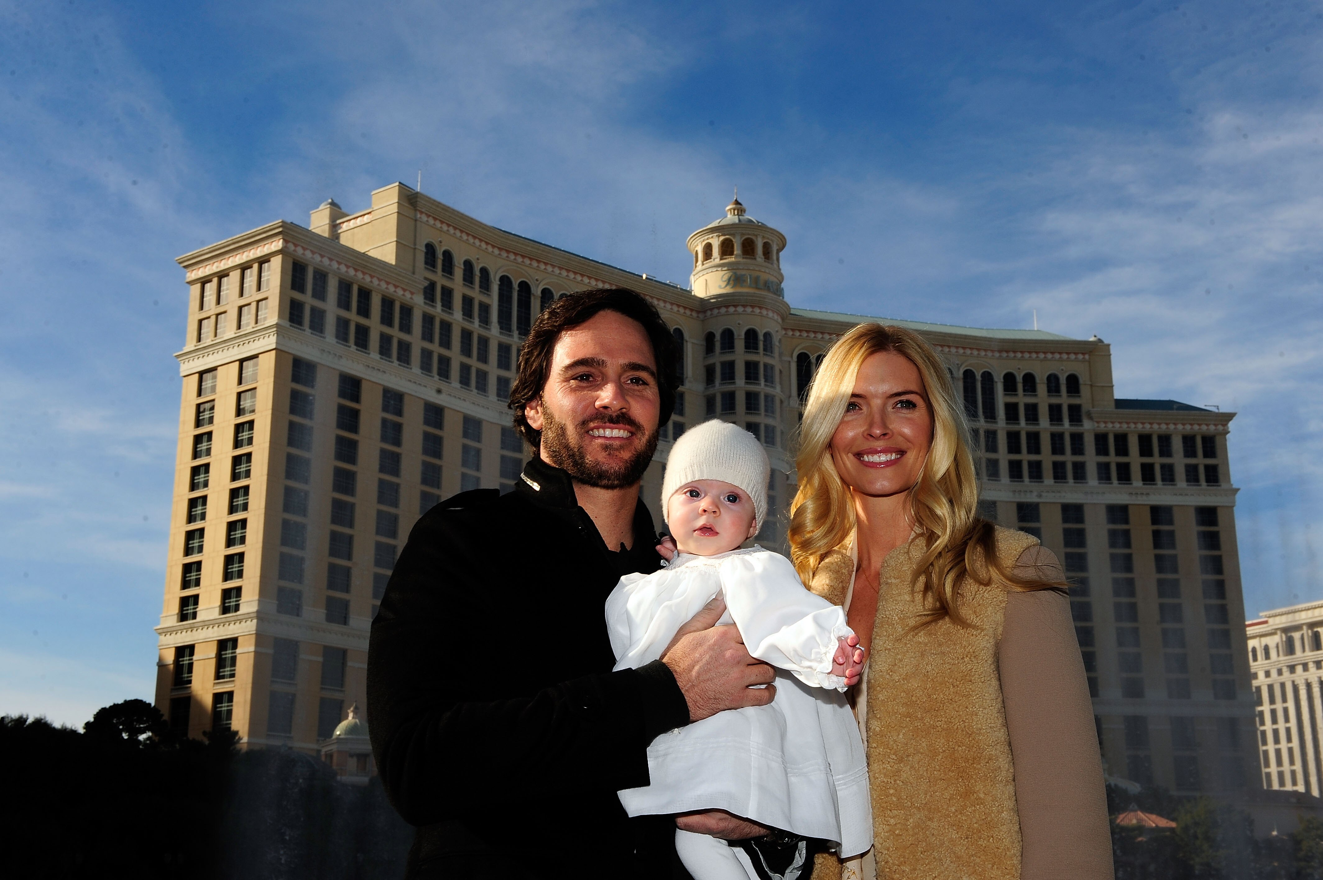 LAS VEGAS, NV - NOVEMBER 30:  Five-time NASCAR Sprint Cup Series Champion Jimmie Johnson (L), his daughter Genevieve Marie and his wife Chandra (R) pose outside the Bellagio Hotel and Casino Resort during Day 1 of the NASCAR Sprint Cup Series Champions We