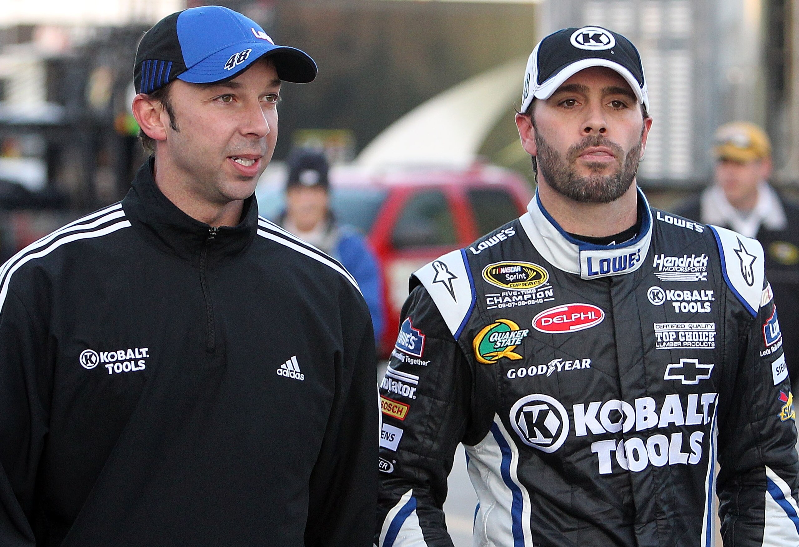 DAYTONA BEACH, FL - FEBRUARY 11:  Jimmie Johnson, driver of the #48 Lowe's Chevrolet, walks in the garage area with crew chief Chad Knaus during practice for the NASCAR Budweiser Shootout at Daytona International Speedway on February 11, 2011 in Daytona B