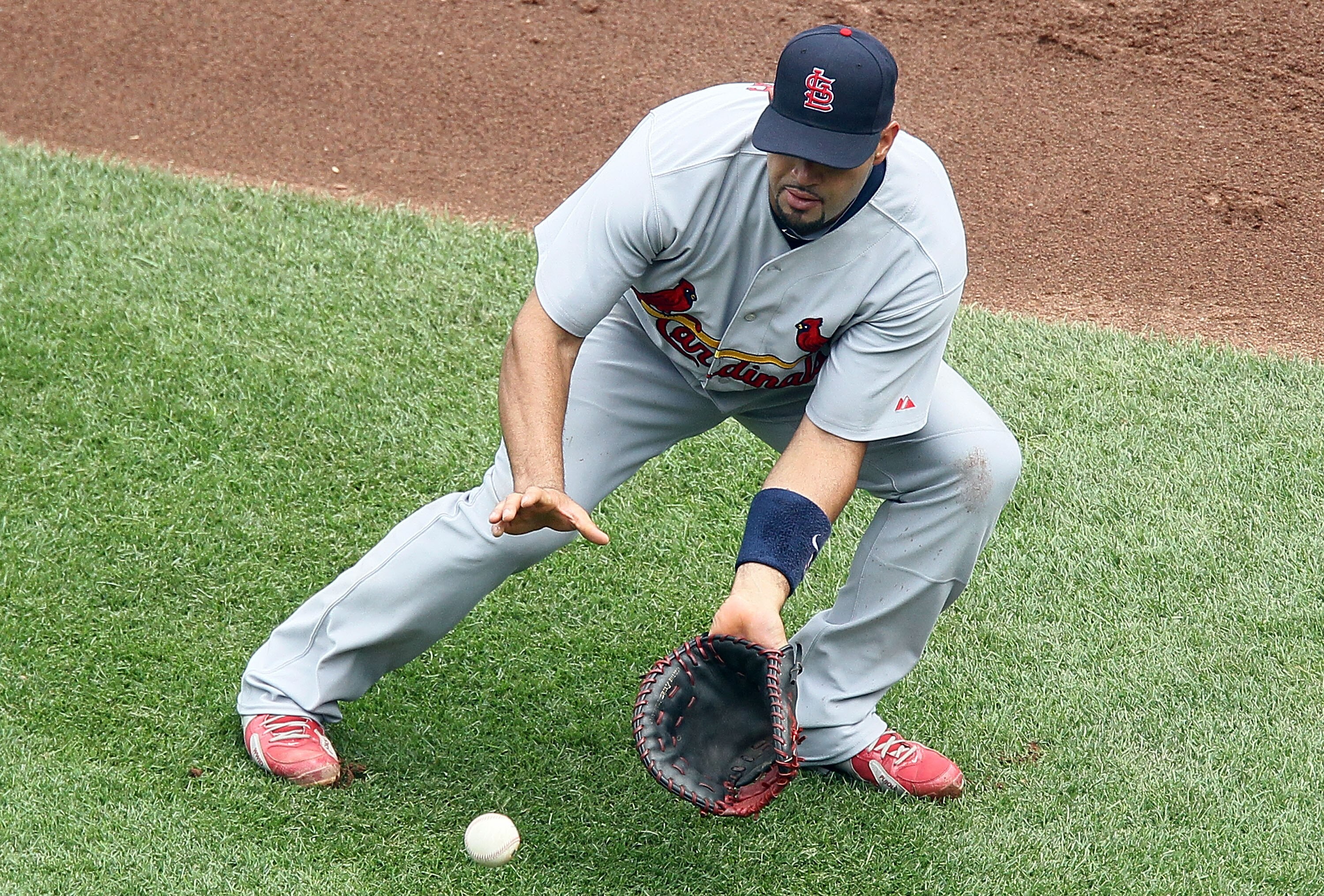 NEW YORK - JULY 29:  Albert Pujols #5 of the St. Louis Cardinals fields the ball against the New York Mets on July 29, 2010 at Citi Field in the Flushing neighborhood of the Queens borough of New York City. The Mets defeated the Cardinals 4-0.  (Photo by