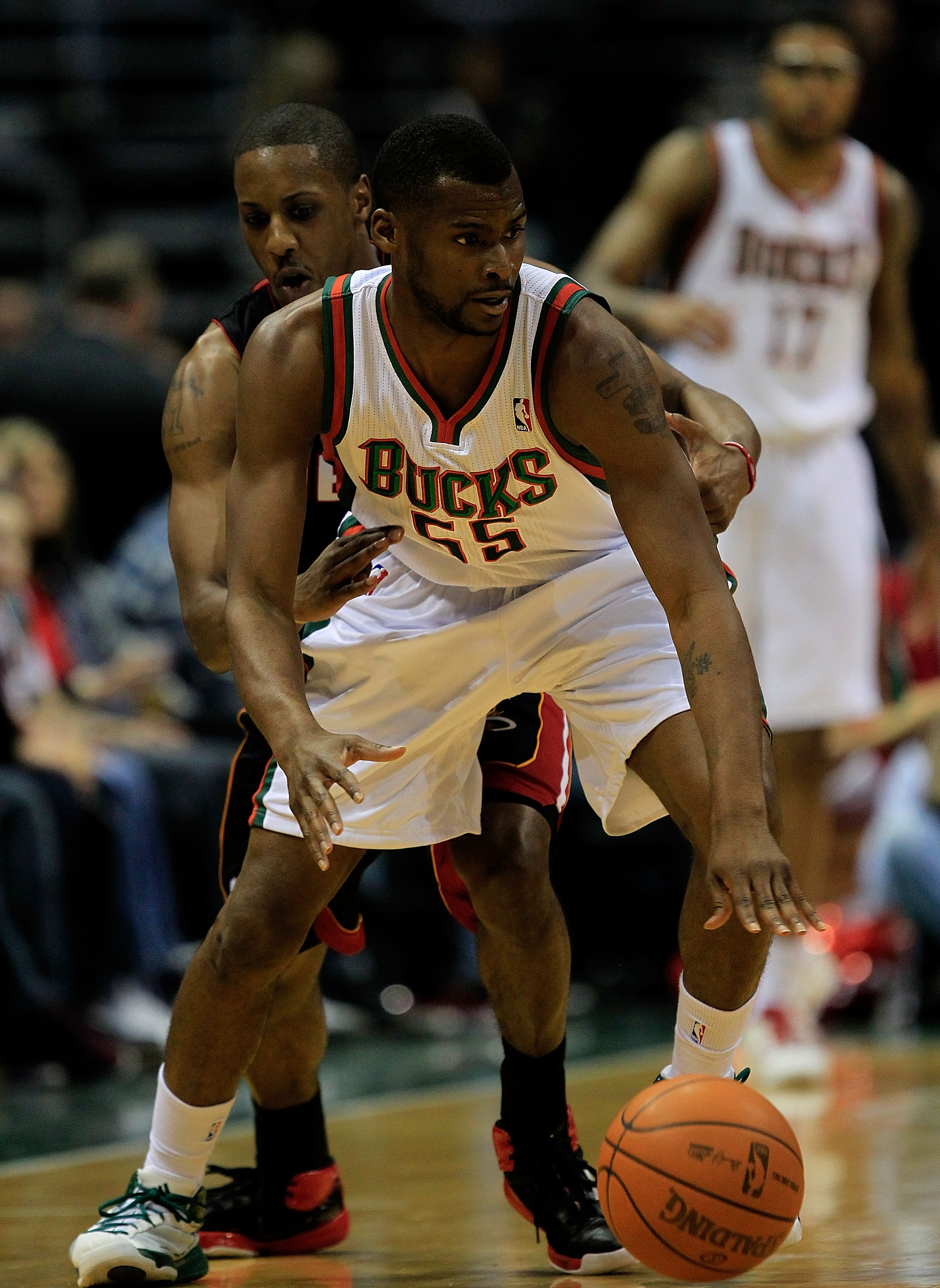 MILWAUKEE, WI - DECEMBER 06: Mario Chalmers #15 of the Miami Heat tries to knock the ball away from Keyon Dooling #55 of the Milwaukee Bucks at the Bradley Center on December 6, 2010 in Milwaukee, Wisconsin. The Heat defeated the Bucks 88-78. NOTE TO USER