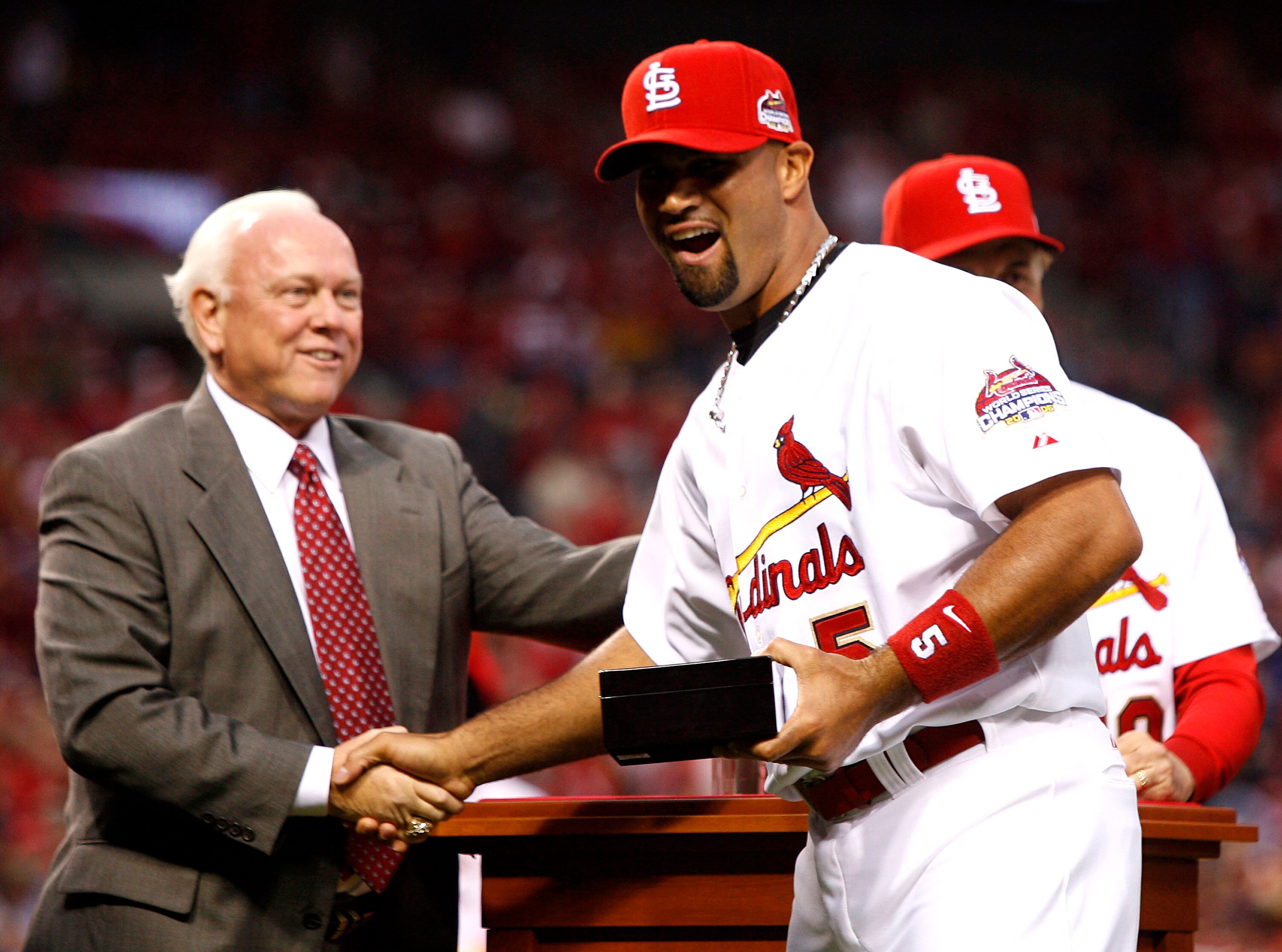 ST. LOUIS, MO - APRIL 3:  General Manager Walt Jocketty presents Albert Pujols #5 of the St. Louis Cardinals with his 2006 World Series Championship ring before playing the New York Mets at Busch Stadium April 3, 2007 in St. Louis, Missouri.  (Photo by Di