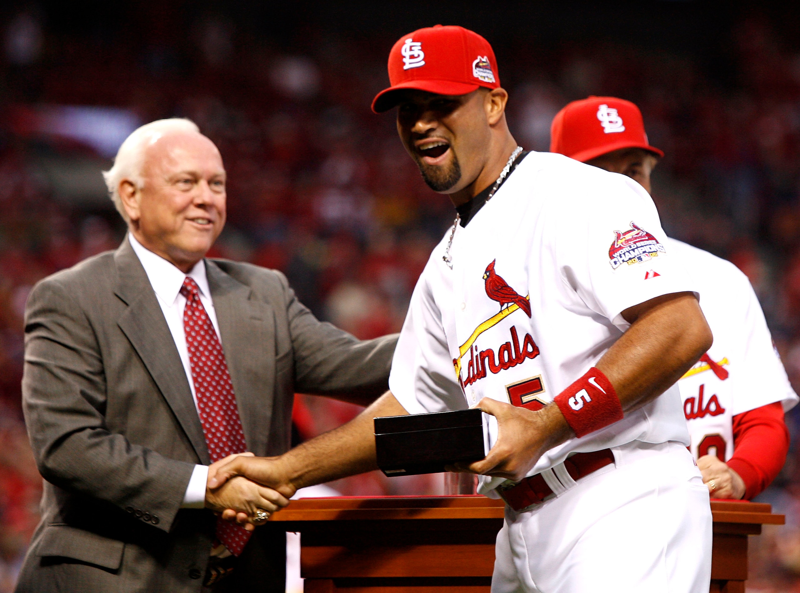 ST. LOUIS, MO - APRIL 3: General Manager Walt Jocketty presents Albert Pujols #5 of the St. Louis Cardinals with his 2006 World Series Championship ring before playing the New York Mets at Busch Stadium April 3, 2007 in St. Louis, Missouri. (Photo by Di ST. LOUIS, MO - APRIL 3: General Manager Walt Jocketty presents Albert Pujols #5 of the St. Louis Cardinals with his 2006 World Series Championship ring before playing the New York Mets at Busch Stadium April 3, 2007 in St. Louis, Missouri. (Photo by Di