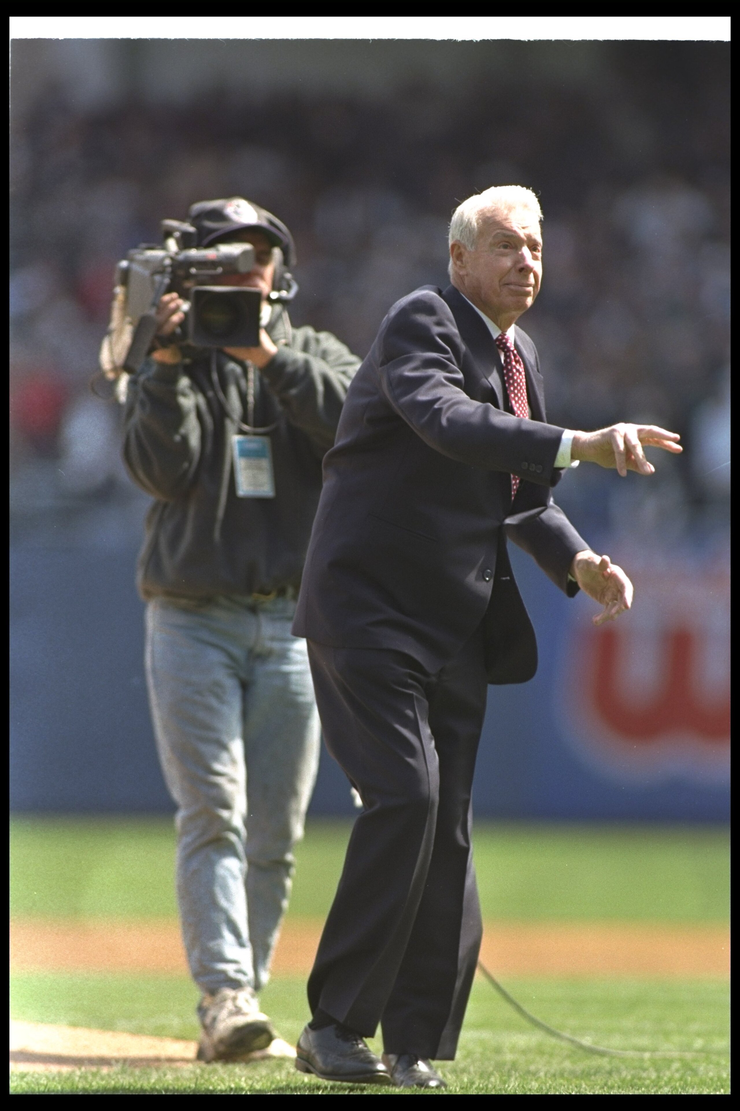 11 Apr 1997: Yankee Hall of Famer Joe Dimaggio throws out the ceremonial first pitch before the New York Yankees 3-1 loss to the Oakland Athletics at Yankee Stadium in Bronx, New York.