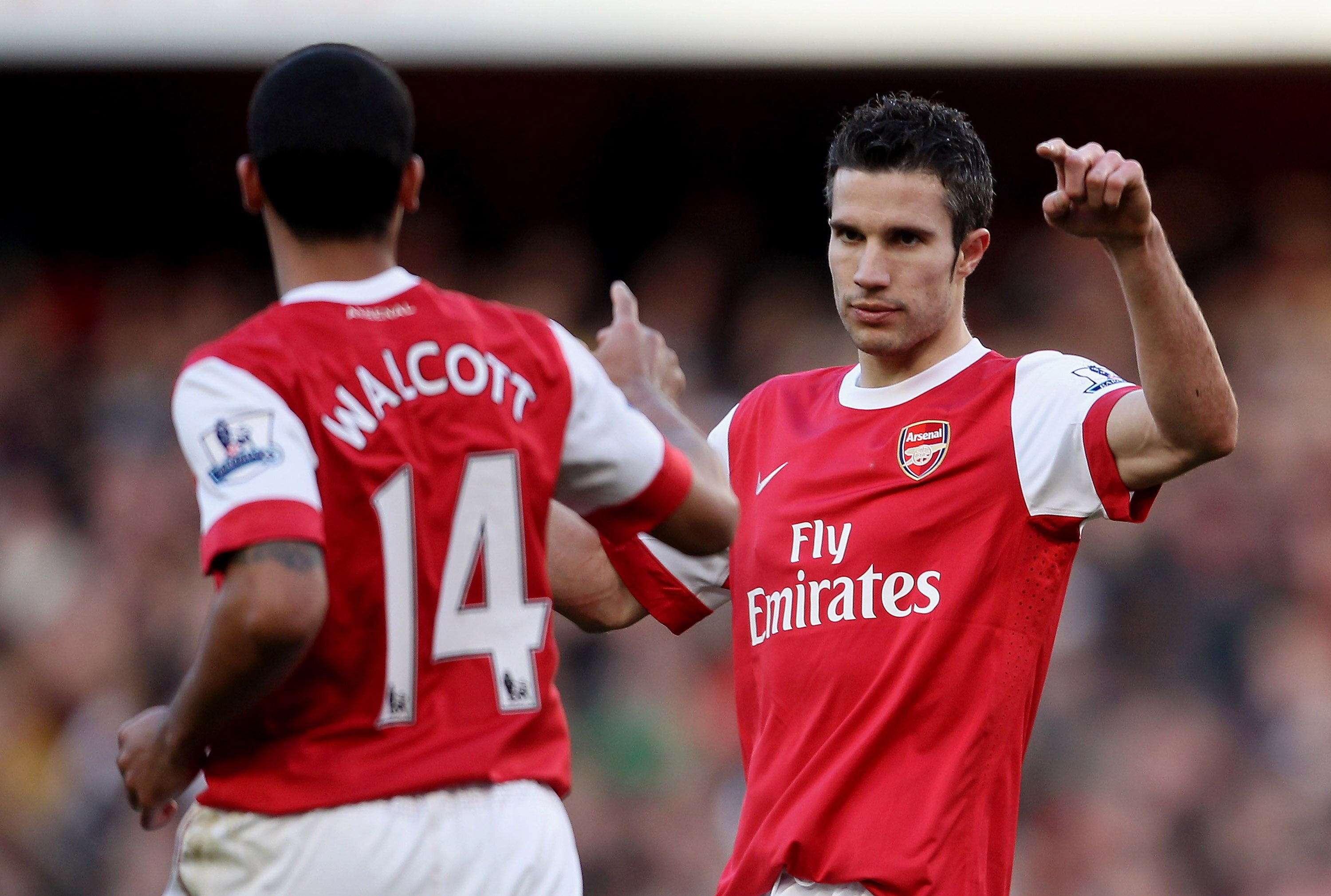 LONDON, ENGLAND - FEBRUARY 12:  Robin Van Persie of Arsenal (R) celebrates with Theo Walcott after scoring their second goal during the Barclays Premier League match between Arsenal and Wolverhampton Wanderers on February 12, 2011 in London, England.  (Ph