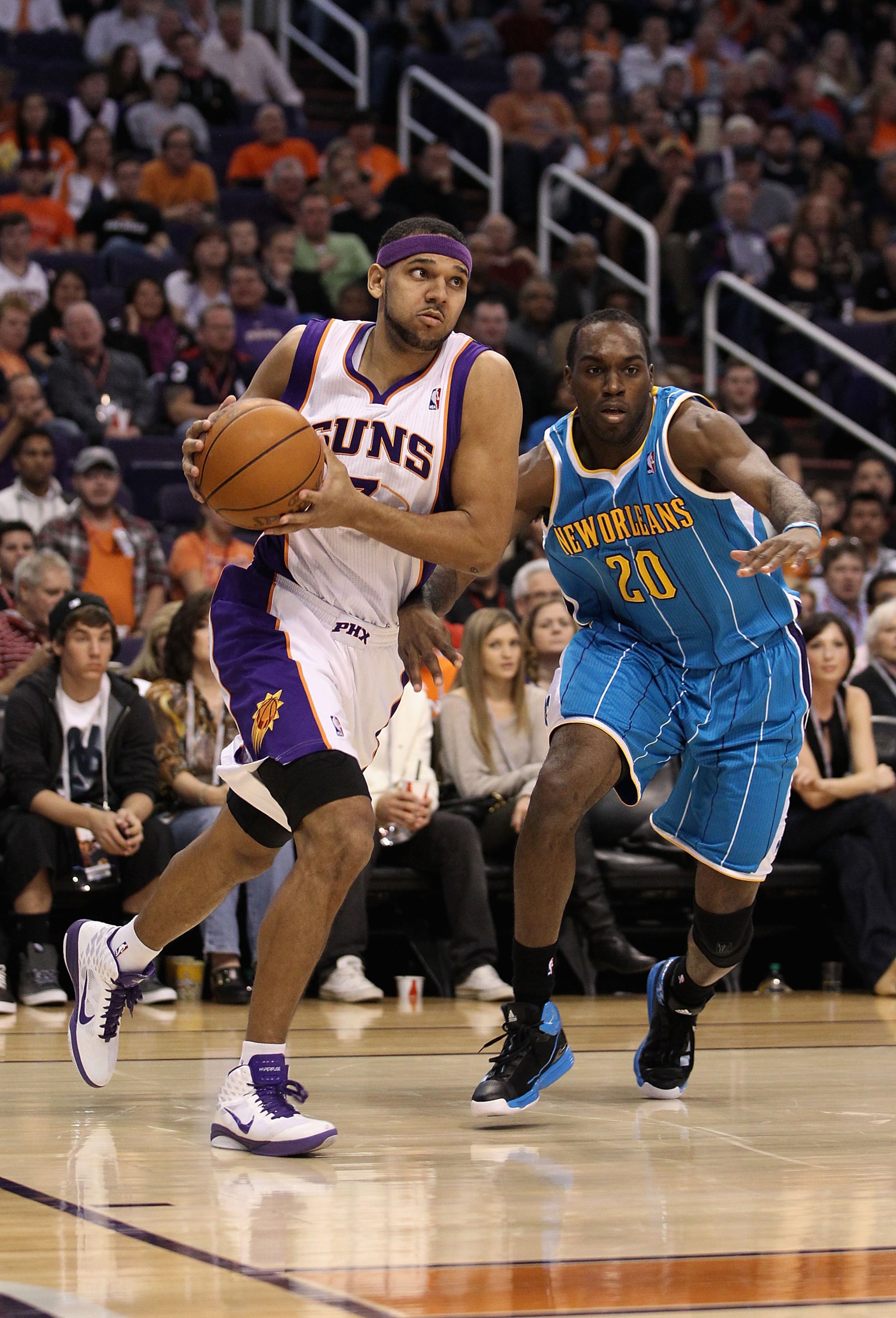 PHOENIX, AZ - JANUARY 30:  Jared Dudley #3 of the Phoenix Suns drives the ball past Quincy Pondexter #20 of the New Orleans Hornets during the NBA game at US Airways Center on January 30, 2011 in Phoenix, Arizona.  The Suns defeated the Hornets 104-102. N