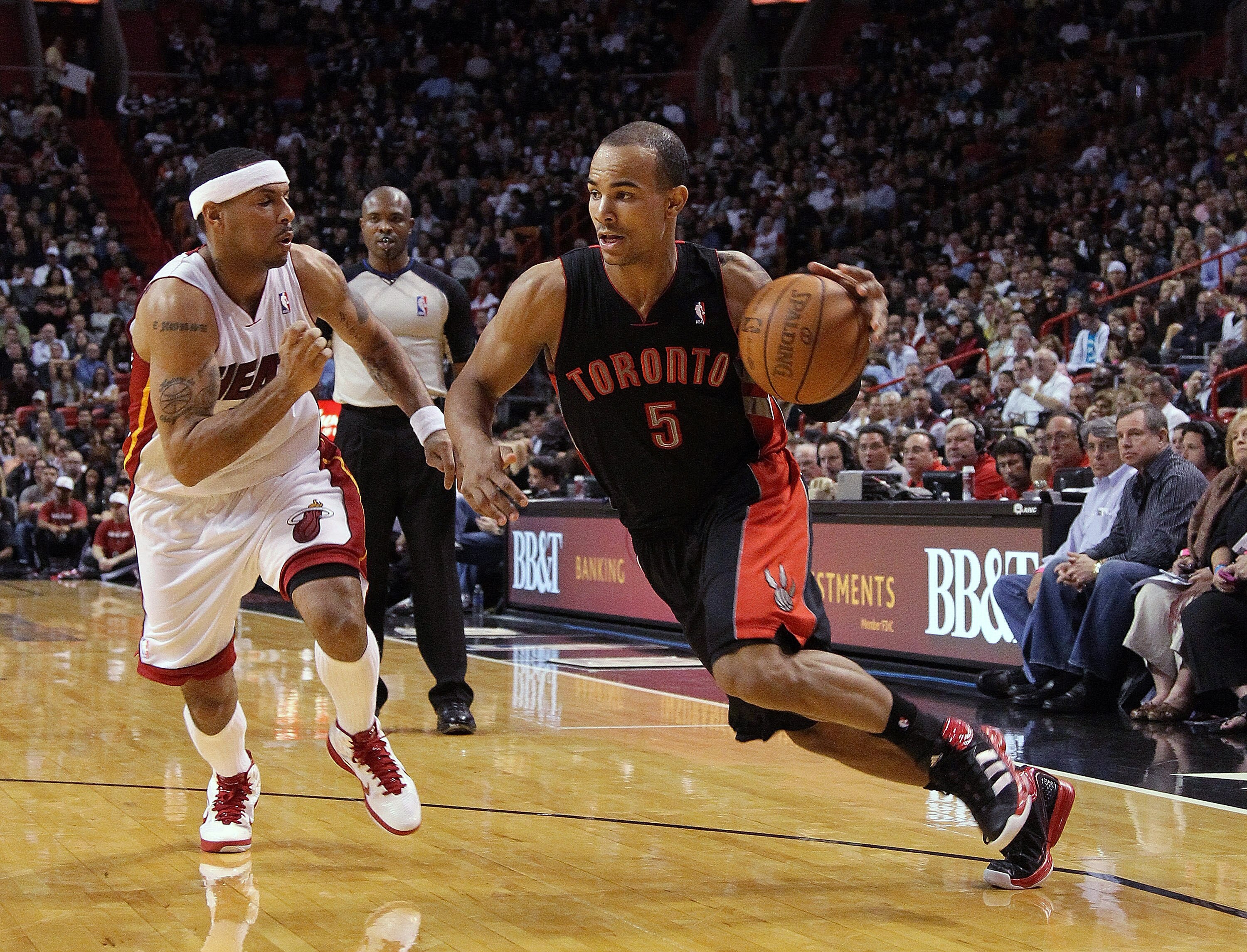 MIAMI, FL - JANUARY 22:  Jerryd Bayless #5 of the Toronto Raptors dribbles past Eddie House #55 of the Miami Heat during a game at American Airlines Arena on January 22, 2011 in Miami, Florida. NOTE TO USER: User expressly acknowledges and agrees that, by