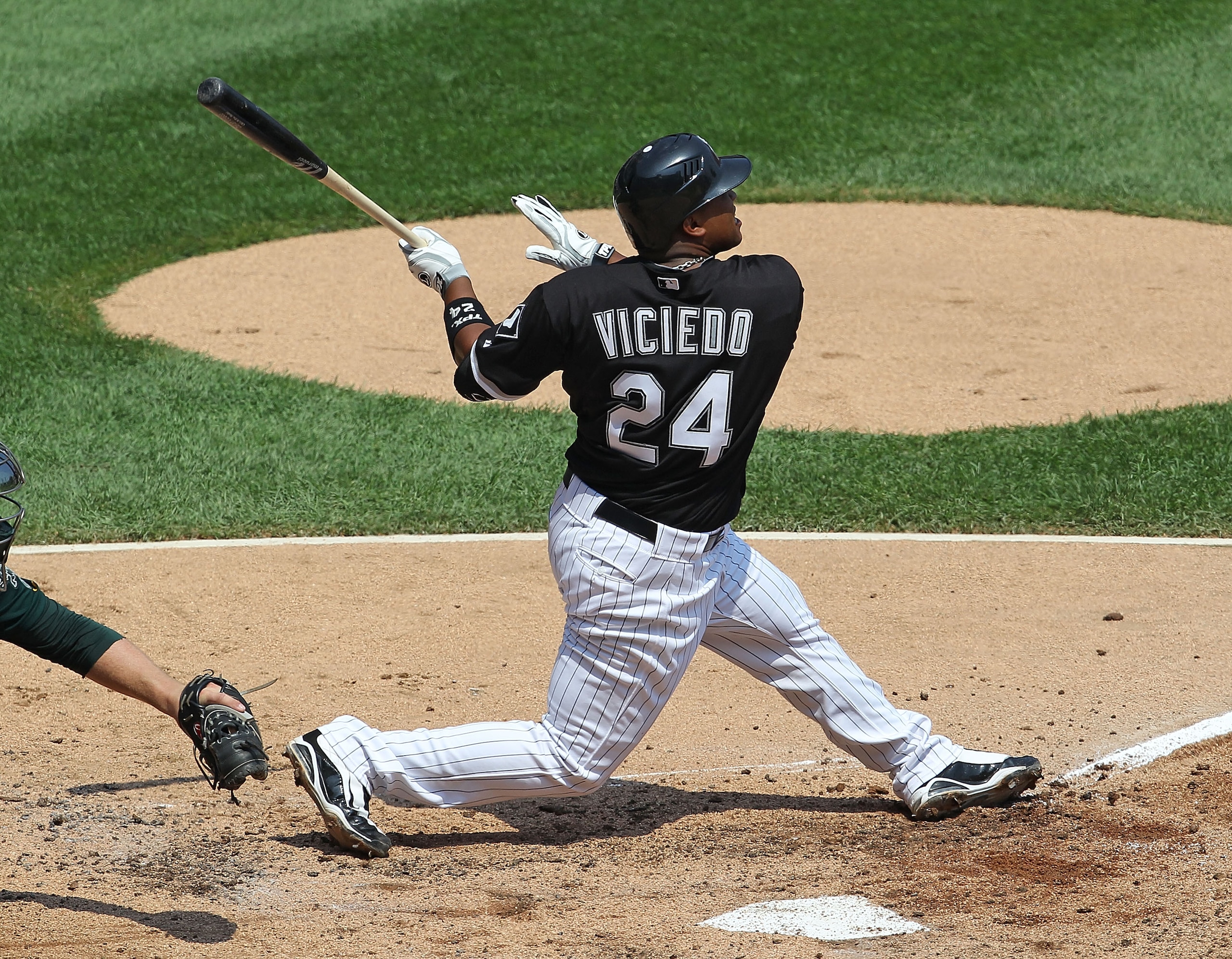 CHICAGO - AUGUST 01: Dayan Viciedo #24 of the Chicago White Sox hits the ball against the Oakland Athletics at U.S. Cellular Field on August 1, 2010 in Chicago, Illinois. The White Sox defeated the Athletics 4-1. (Photo by Jonathan Daniel/Getty Images)