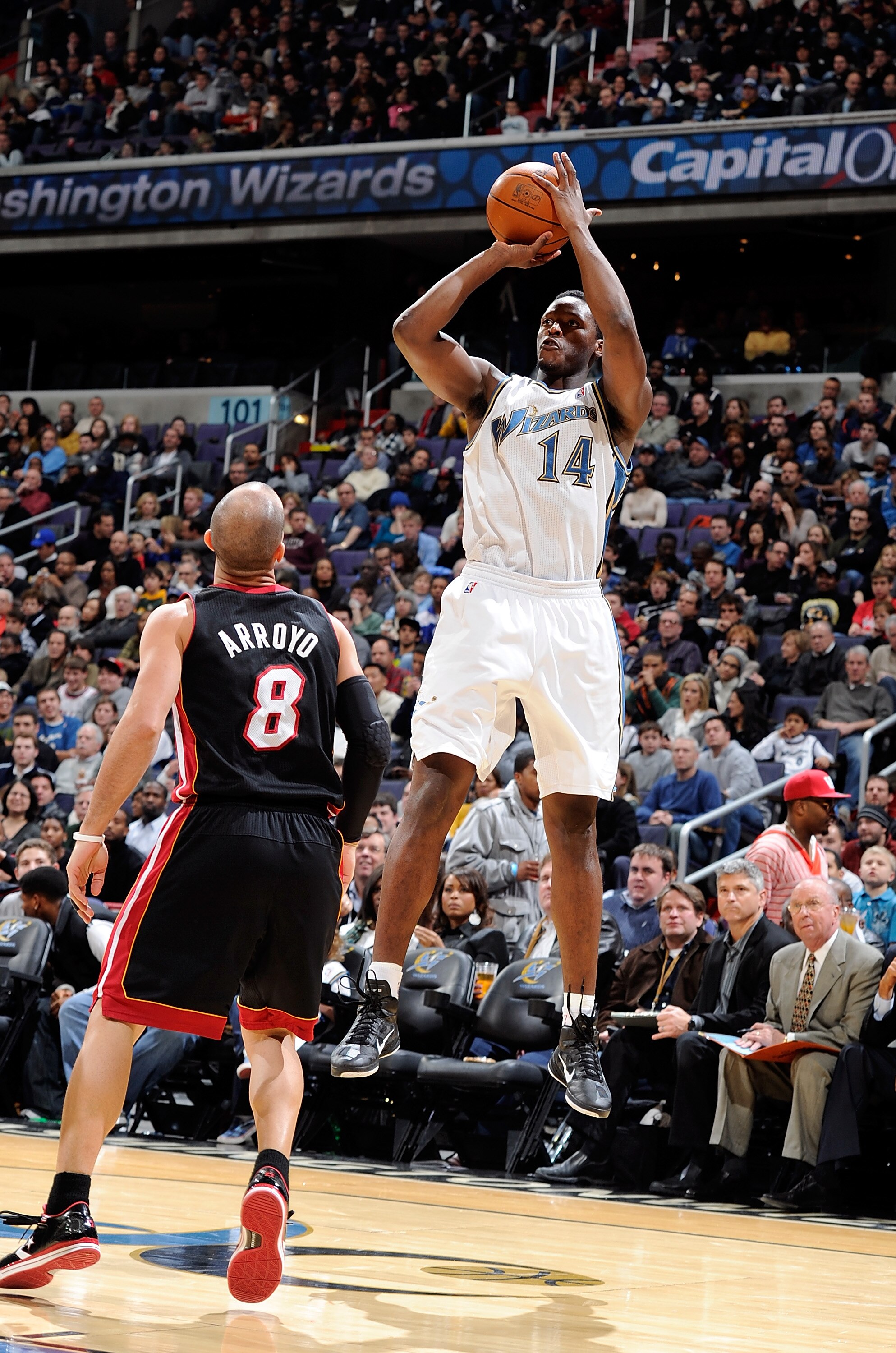 WASHINGTON, DC - DECEMBER 18:  Al Thornton #14 of the Washington Wizards  shoots over Carlos Arroyo #8 of the Miami Heat at the Verizon Center on December 18, 2010 in Washington, DC. NOTE TO USER: User expressly acknowledges and agrees that, by downloadin