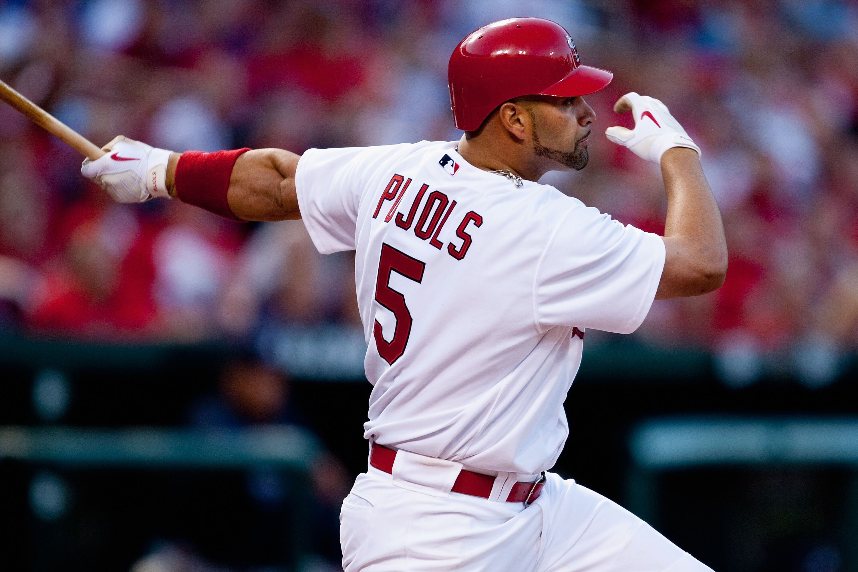 ST. LOUIS - APRIL 28: Albert Pujols #5 of the St. Louis Cardinals hits an RBI single against the Atlanta Braves at Busch Stadium on April 28, 2010 in St. Louis, Missouri.  (Photo by Dilip Vishwanat/Getty Images)