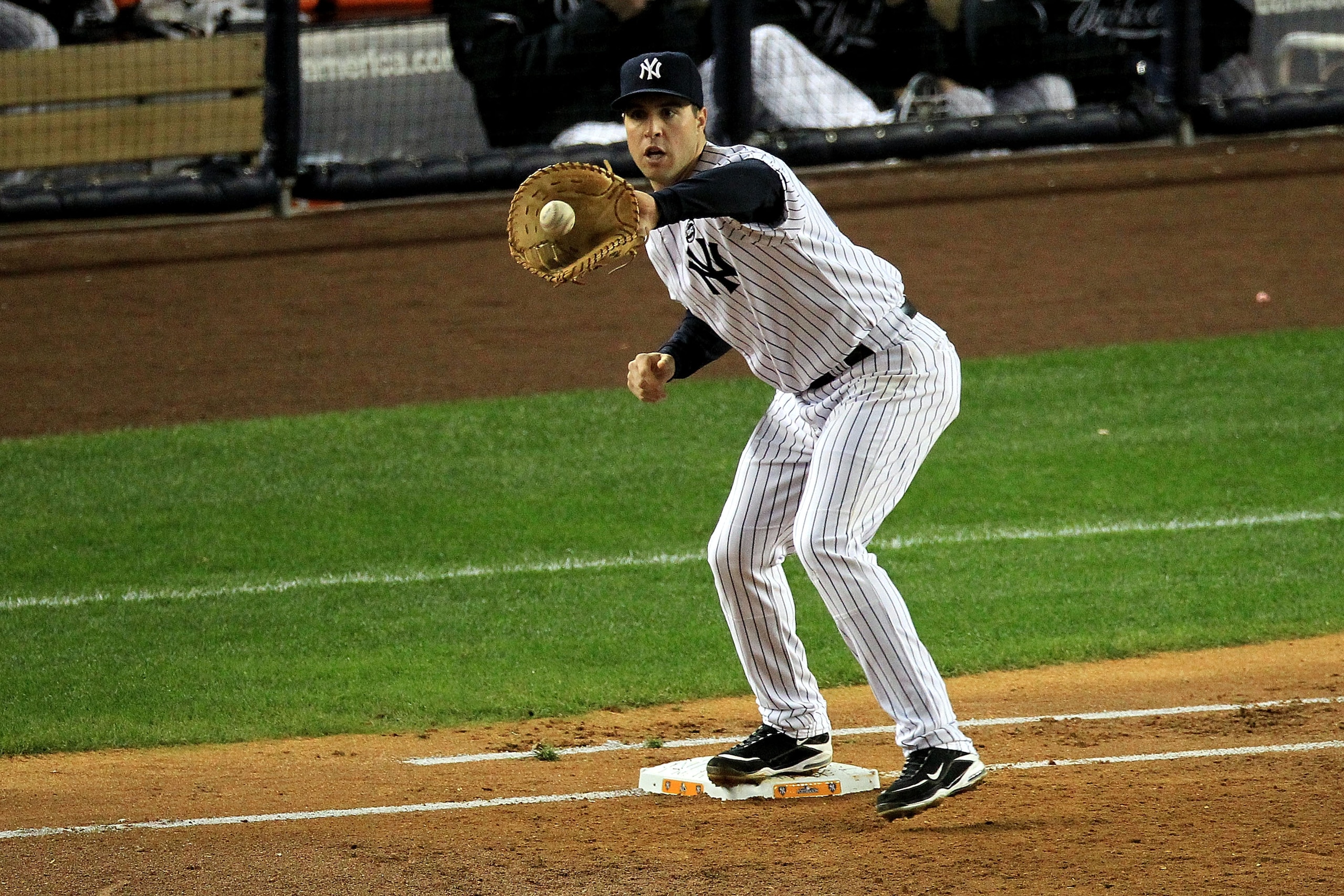 NEW YORK - OCTOBER 18:  Mark Teixeira #25 of the New York Yankees catches the ball for a force out against the Texas Rangers in Game Three of the ALCS during the 2010 MLB Playoffs at Yankee Stadium on October 18, 2010 in New York, New York.  (Photo by Tra
