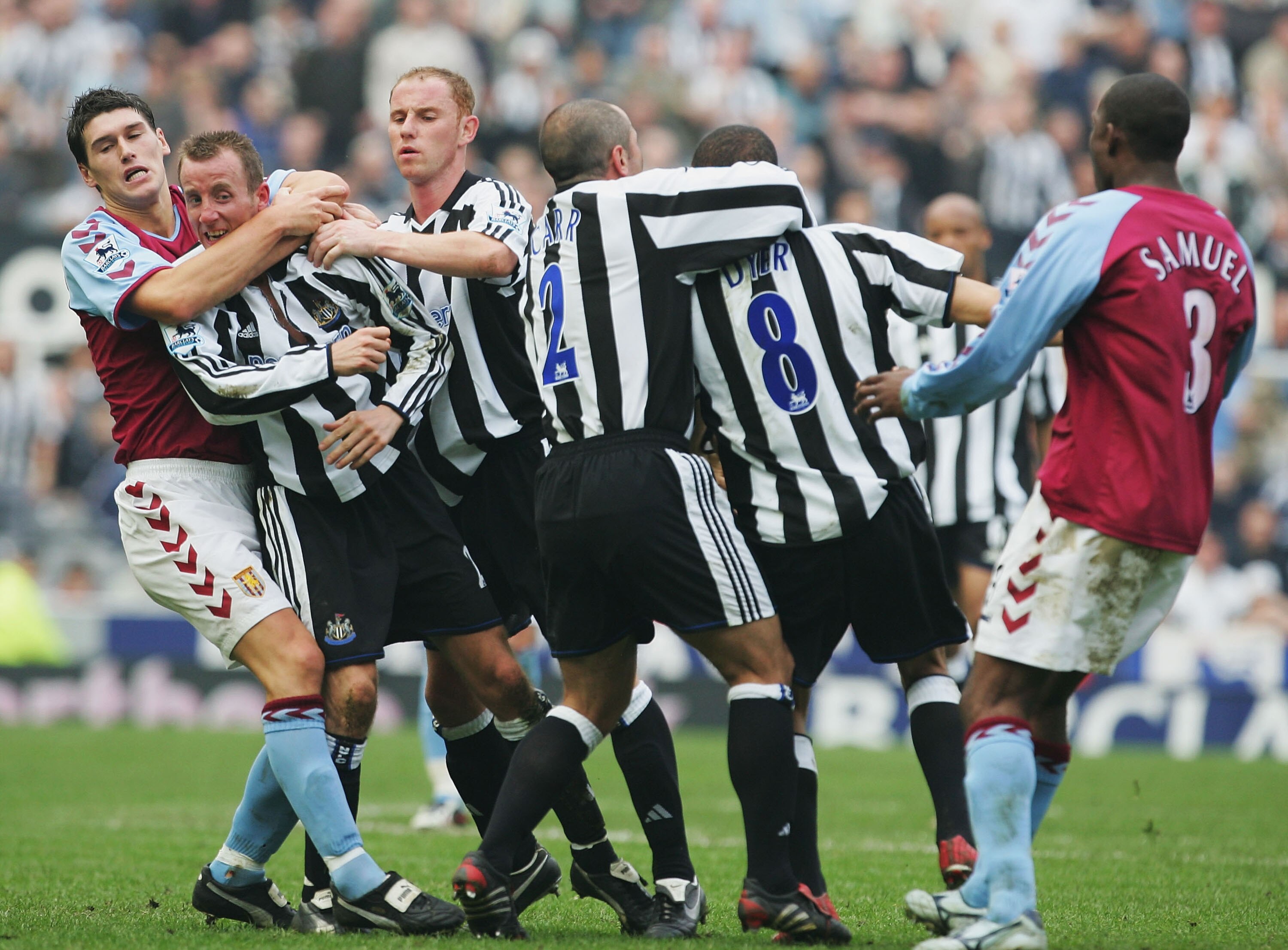 NEWCASTLE, ENGLAND - APRIL 2 :  Gareth Barry of Aston Villa pulls apart the fighting Lee Bowyer and Kieron Dyer of Newcastle during the FA Barclays Premiership match between Newcastle United and Aston Villa at St James Park on April 2, 2005 in Newcastle,