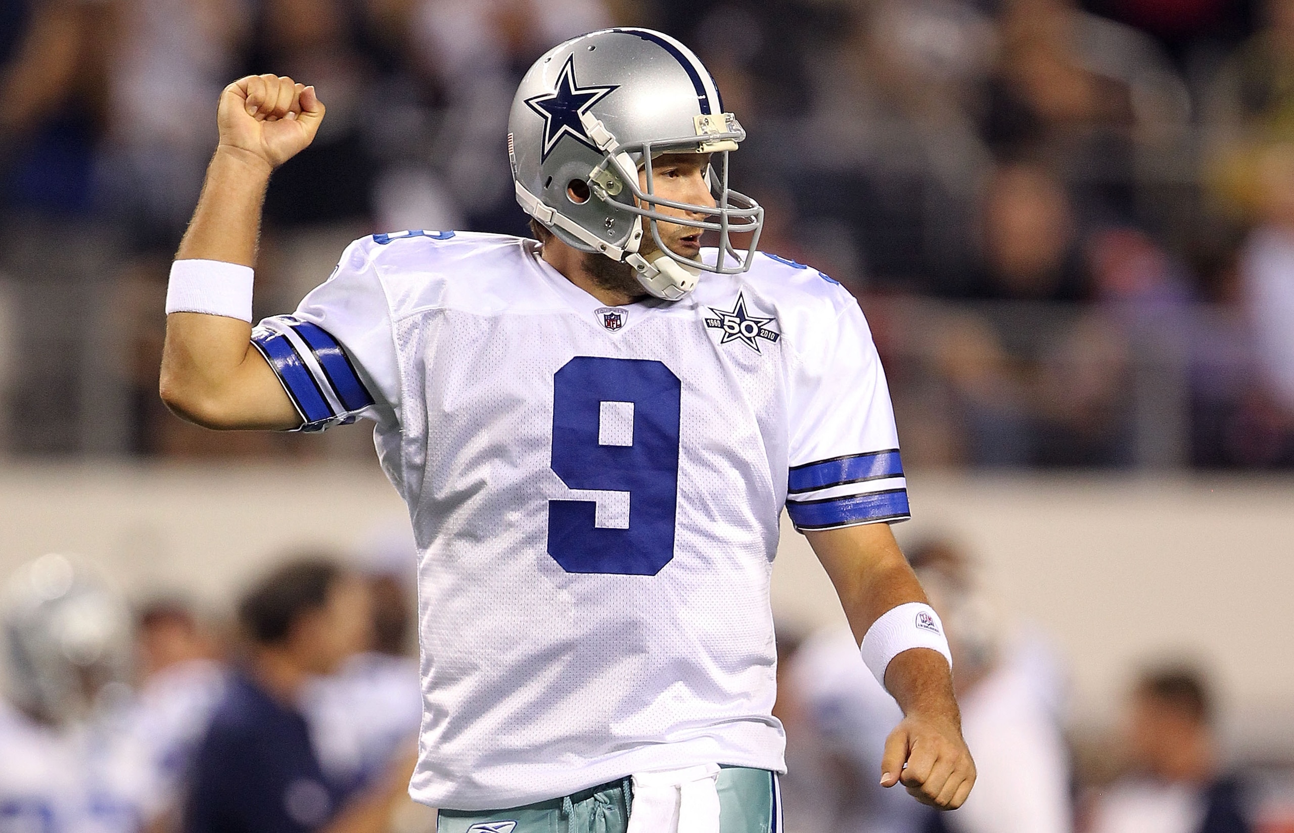 ARLINGTON, TX - OCTOBER 25:  Quarterback Tony Romo #9 of the Dallas Cowboys celebrates a touchdown by Jason Witten against the New York Giants in the first quarter at Cowboys Stadium on October 25, 2010 in Arlington, Texas.  (Photo by Ronald Martinez/Gett