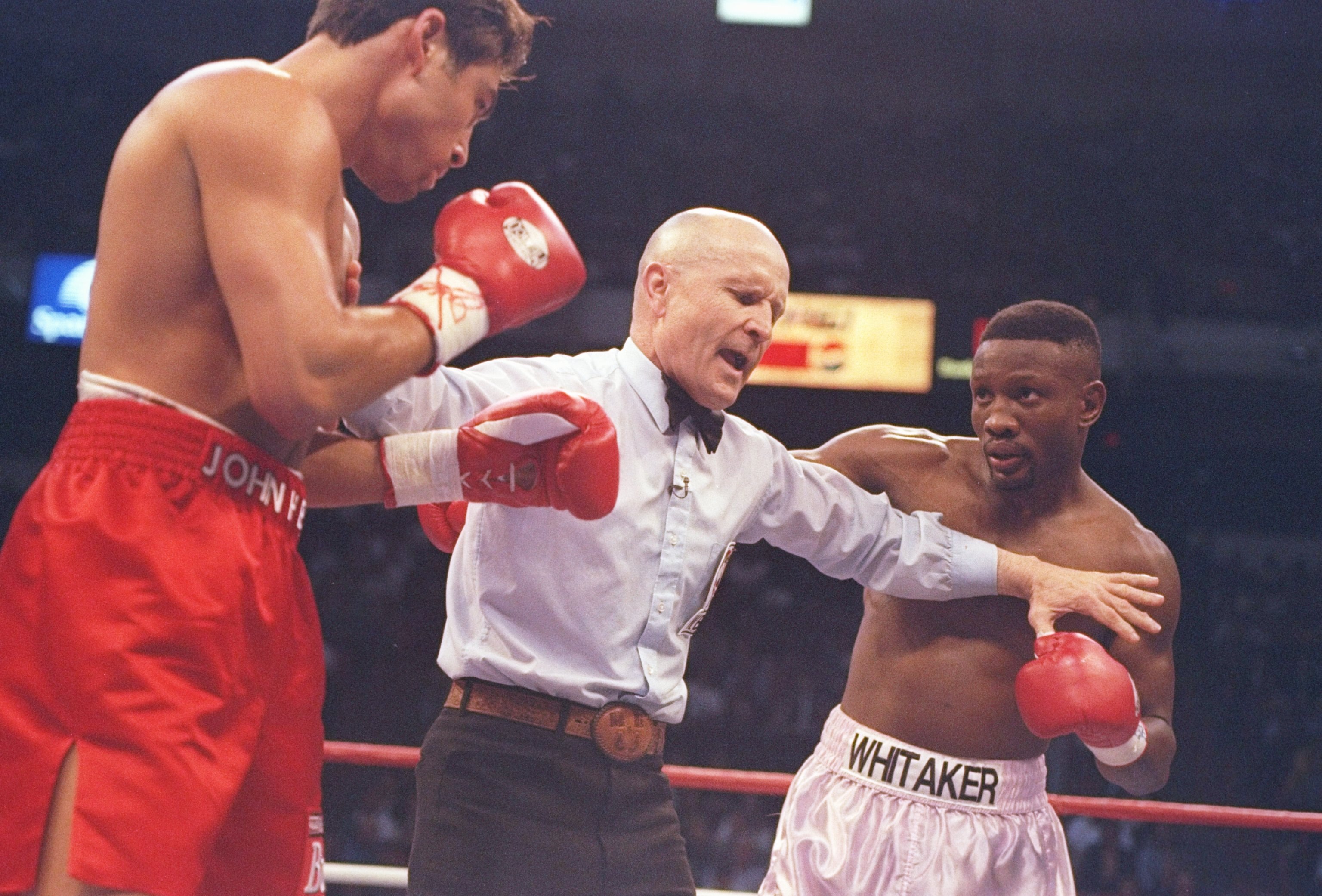 12 Apr 1997:  Referee Mills Lane separates Oscar De La Hoya and Pernell Whitaker during their bout at the Thomas and Mack Center in Las Vegas, Nevada.  De la Hoya won the fight by a decision. Mandatory Credit: Al Bello  /Allsport