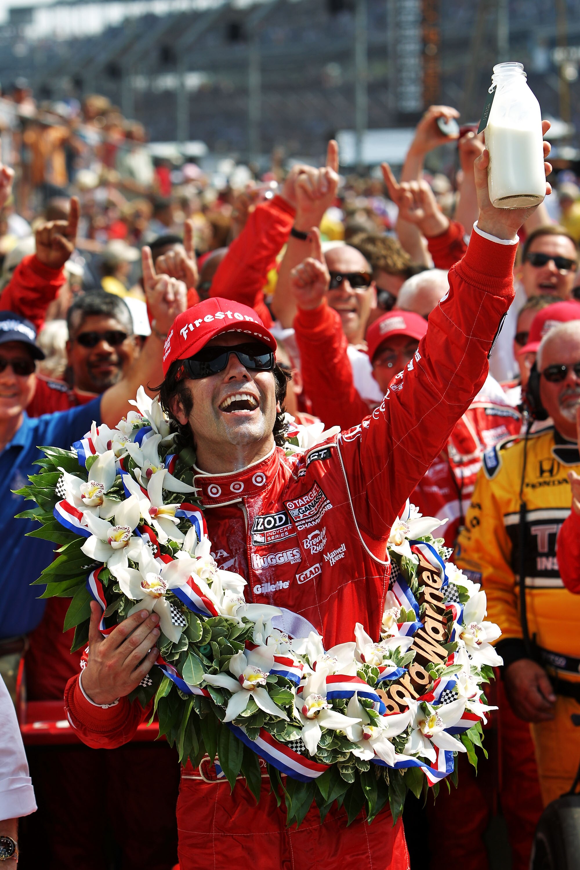 INDIANAPOLIS - MAY 30:  Dario Franchitti of Scotland, driver of the #10 Target Chip Ganassi Racing Dallara Honda, holds up the ceremonial winner's milk over in victory lane in celebration of winning the IZOD IndyCar Series 94th running of the Indianapolis