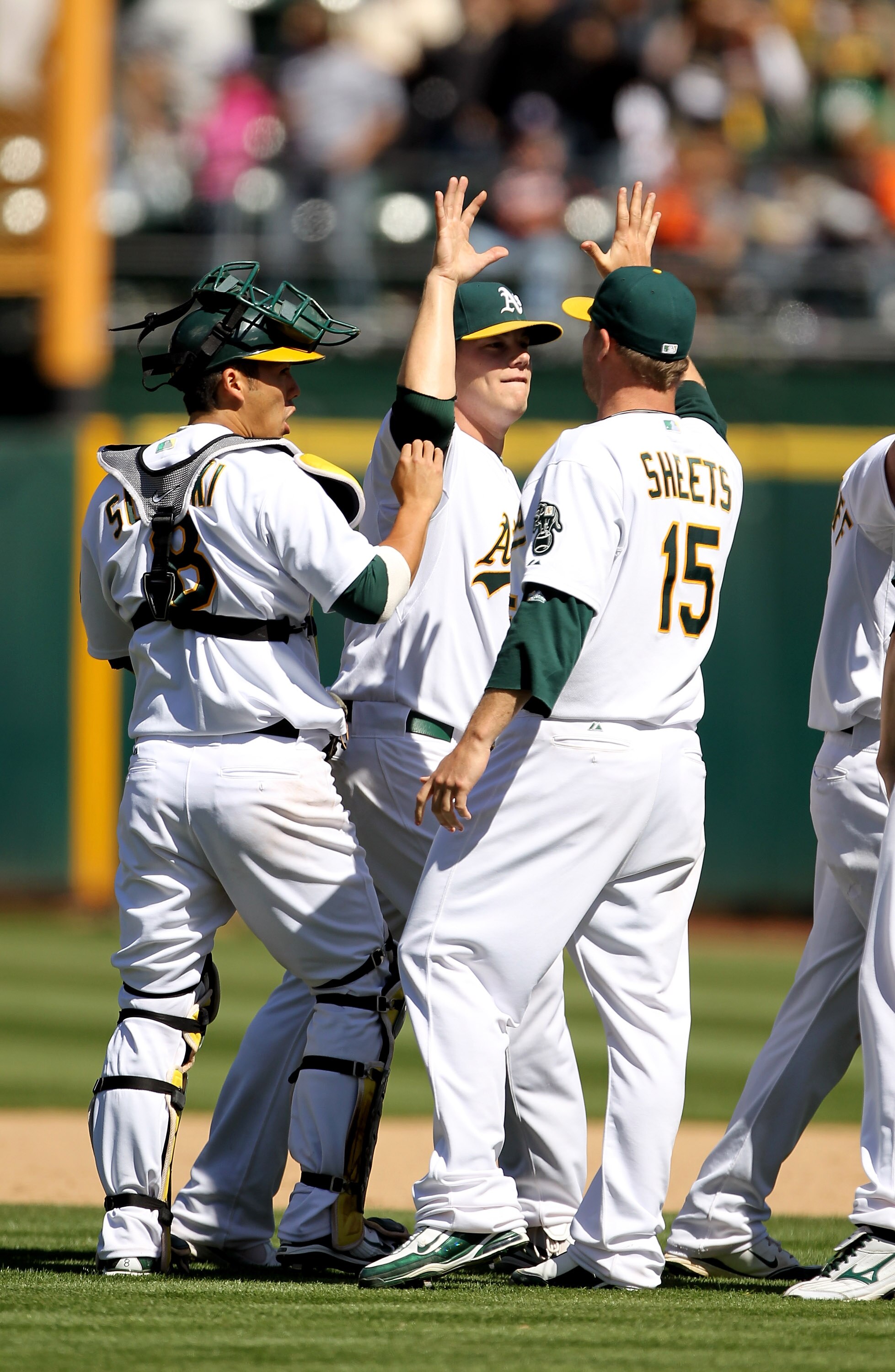 OAKLAND, CA - MAY 23:  Ben Sheets #15, Andrew Bailey #40 and  Kurt Suzuki #8 of the Oakland Athletics congratulate one another after the Athletics beat the San Francisco Giants at the Oakland-Alameda County Coliseum on May 23, 2010 in Oakland, California.