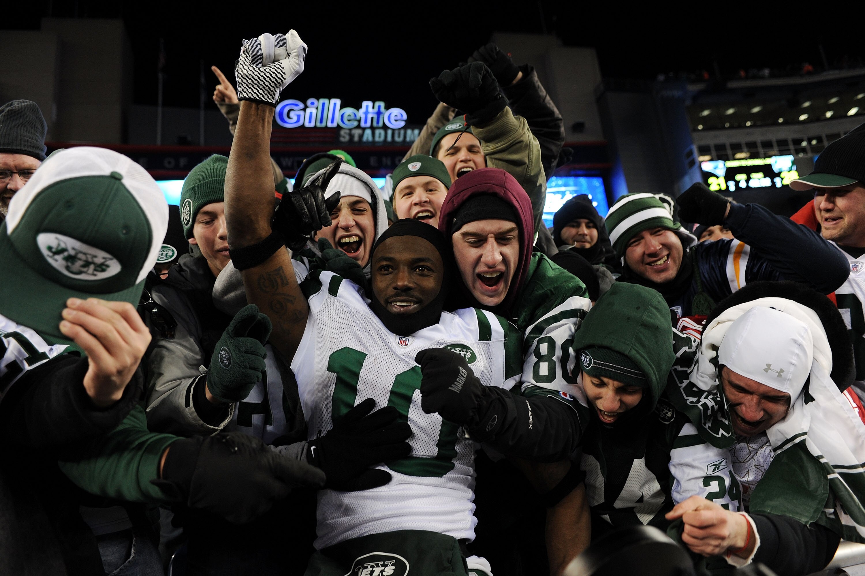 FOXBORO, MA - JANUARY 16:  Santonio Holmes #10 of the New York Jets celebrates with fans after the Jets defeated the Patriots 28 to 21 in their 2011 AFC divisional playoff game at Gillette Stadium on January 16, 2011 in Foxboro, Massachusetts.  (Photo by
