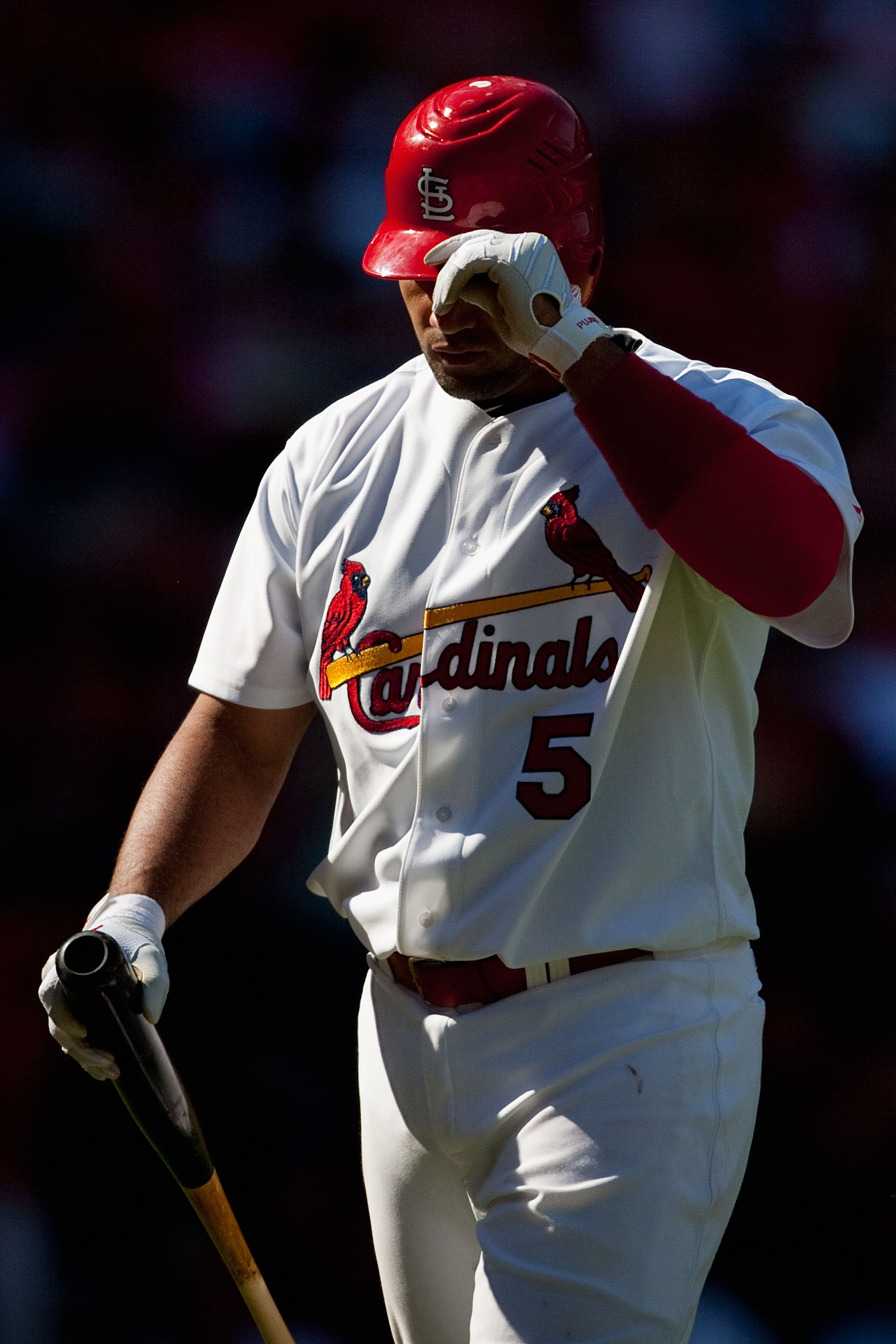 ST. LOUIS - SEPTEMBER 5: Albert Pujols #5 of the St. Louis Cardinals returns to the dugout after striking out against the Cincinnati Reds at Busch Stadium on September 5, 2010 in St. Louis, Missouri.  The Cardinals beat the Reds 4-2.  (Photo by Dilip Vish