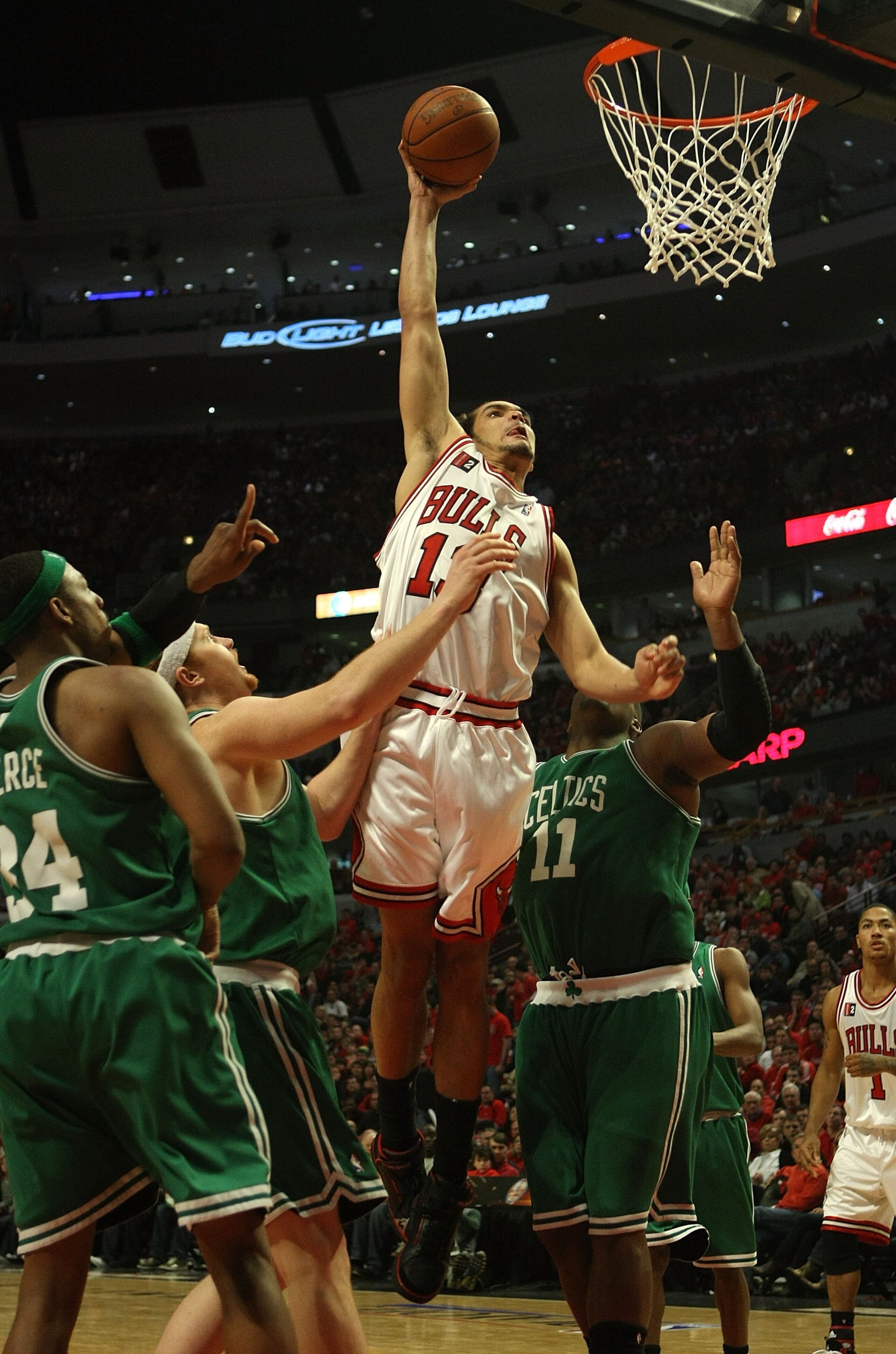 CHICAGO - APRIL 26: Joakim Noah #13 of the Chicago Bulls goes up for a dunk against Paul Pierce #34, Brian Scalabrine #44 and Glen Davis #11 of the Boston Celtics in Game Four of the Eastern Conference Quarterfinals during the 2009 NBA Playoffs at the Uni