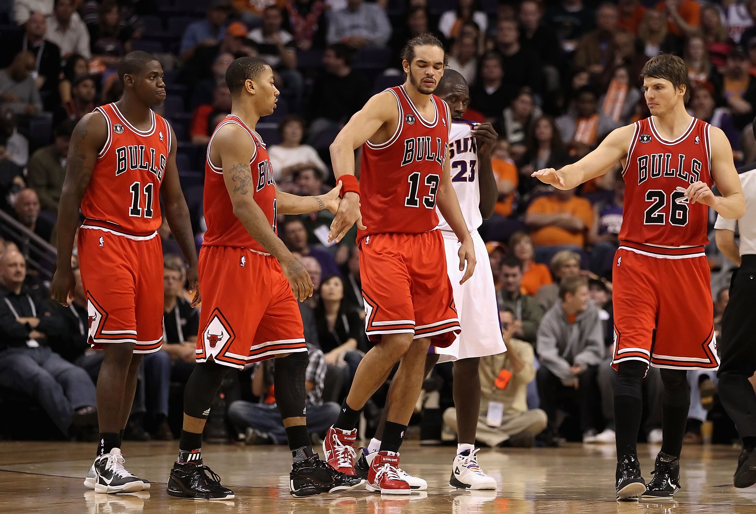 PHOENIX - NOVEMBER 24:  Derrick Rose #1 of the Chicago Bulls high fives teammate Joakim Noah #13 after scoring against the Phoenix Suns during the NBA game at US Airways Center on November 24, 2010 in Phoenix, Arizona. The Bulls defeated the Suns 123-115