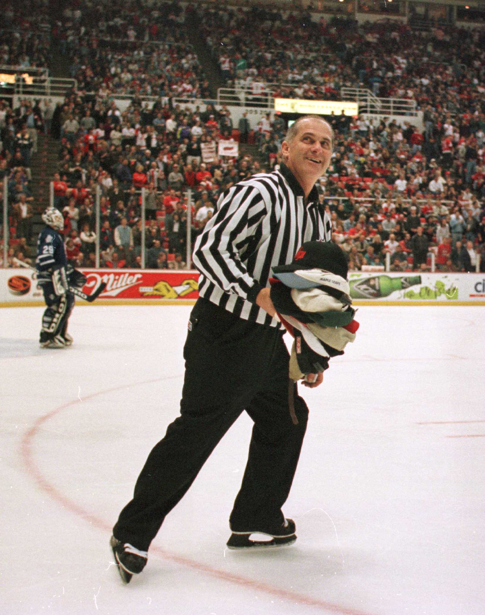 27 Nov 1996:  Linesman Ray Scapinello collects hats from the rink after Brendan Shanahan's of the Detroit Red Wings hat trick in the second period at Joe Louis Arena in Detroit, Michigan. Detroit defeated Toronto 5-2.  Mandatory Credit: Rick Stewart/Allsp