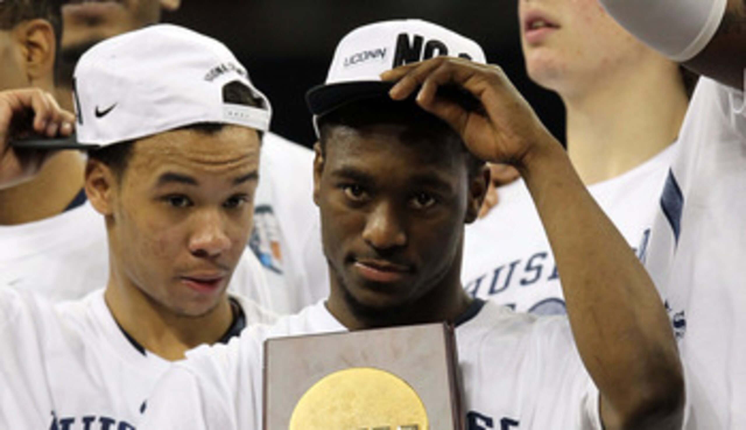 HOUSTON, TX - APRIL 04:  Kemba Walker #15 of the Connecticut Huskies holds the trophy as he and his team celebrate after defeating the Butler Bulldogs to win the National Championship Game of the 2011 NCAA Division I Men's Basketball Tournament by a score