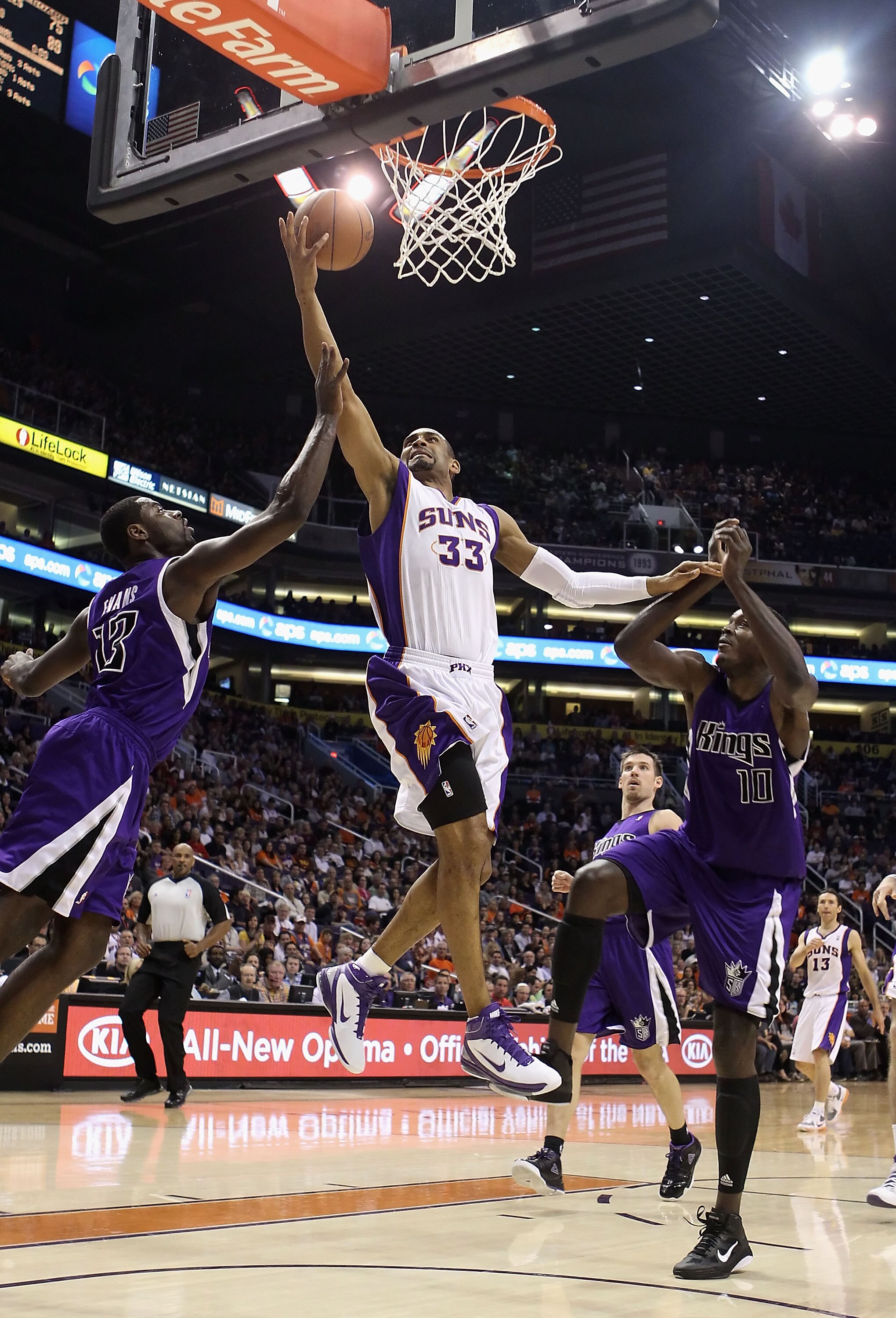 PHOENIX, AZ - FEBRUARY 13:  Grant Hill #13 of the Phoenix Suns lays up a shot past Tyreke Evans #13 and Samuel Dalembert #10 of the Sacramento Kings during the NBA game at US Airways Center on February 13, 2011 in Phoenix, Arizona.  NOTE TO USER: User exp